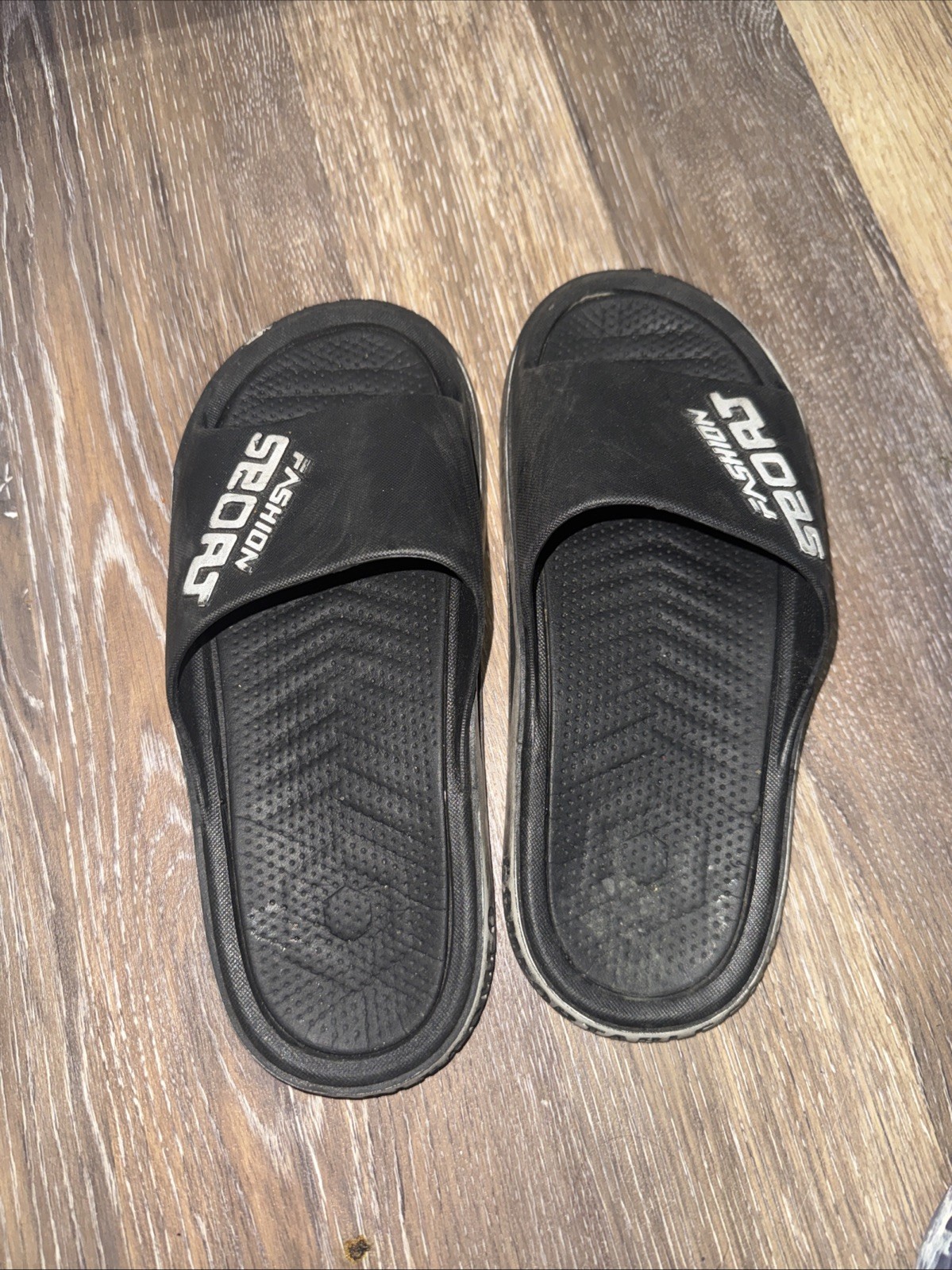 Used black “Fashion Sport” slides. Durable EVA material with non-slip soles.