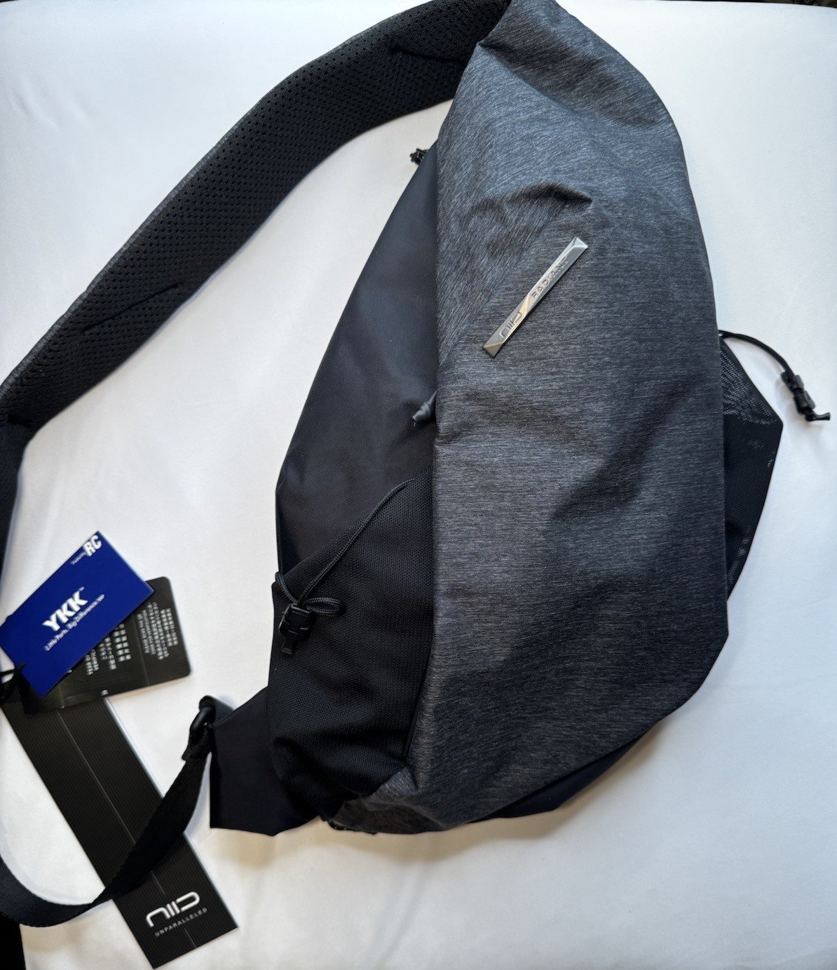 NIID Gray/Black Sling Bag, Zip Closure, Pockets, Adjustable Shoulder Strap, NEW