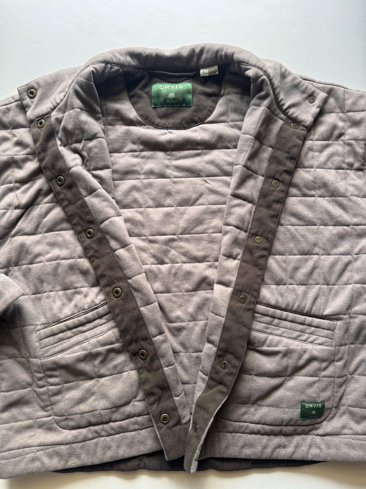 Orvis grey quilted jacket with snap button closure and pockets