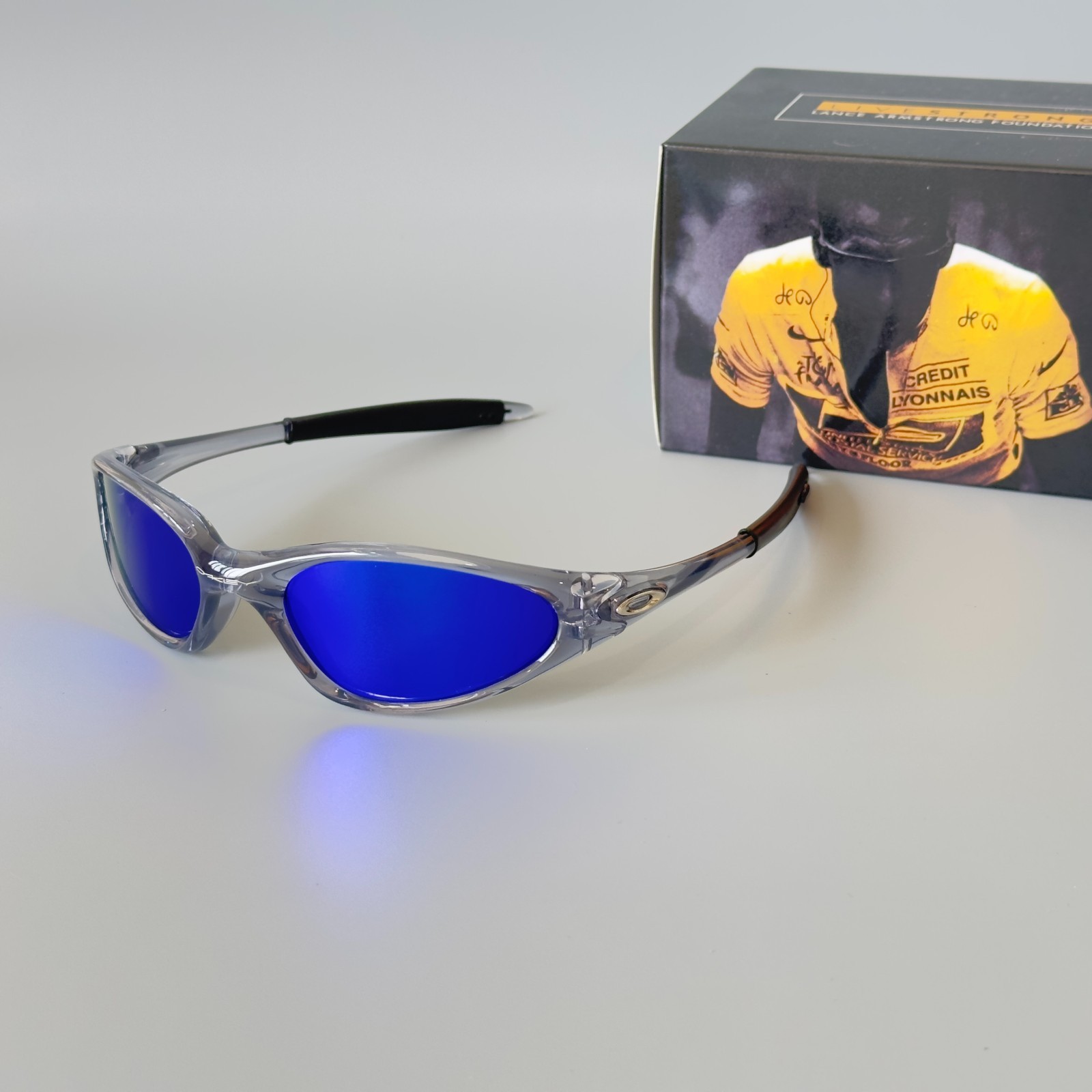 Oakley Minute Gen1 Minute 1.0 Sunglasses Transparent Gray Frame Blue Lens