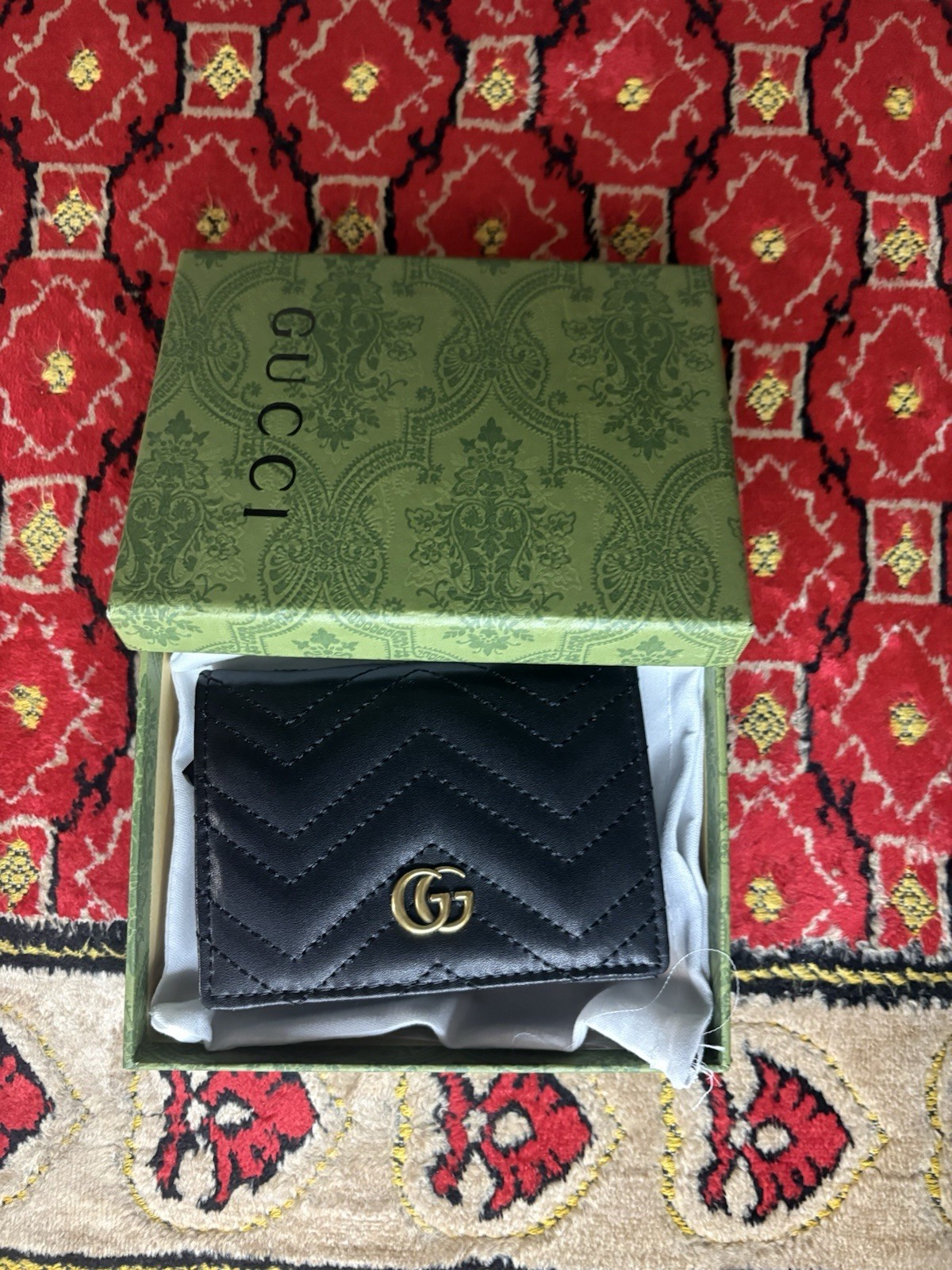 Gucci GG Marmont card case wallet in black quilted chevron leather.