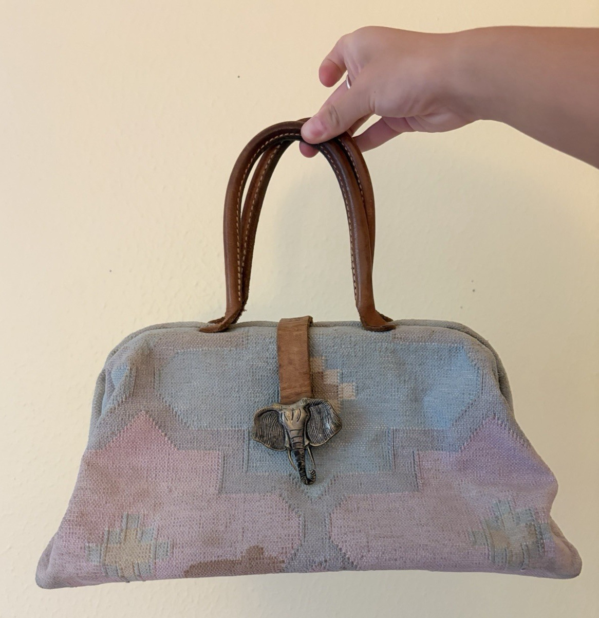 Vintage The Elephant Walk handbag with leather straps and metal elephant clasp