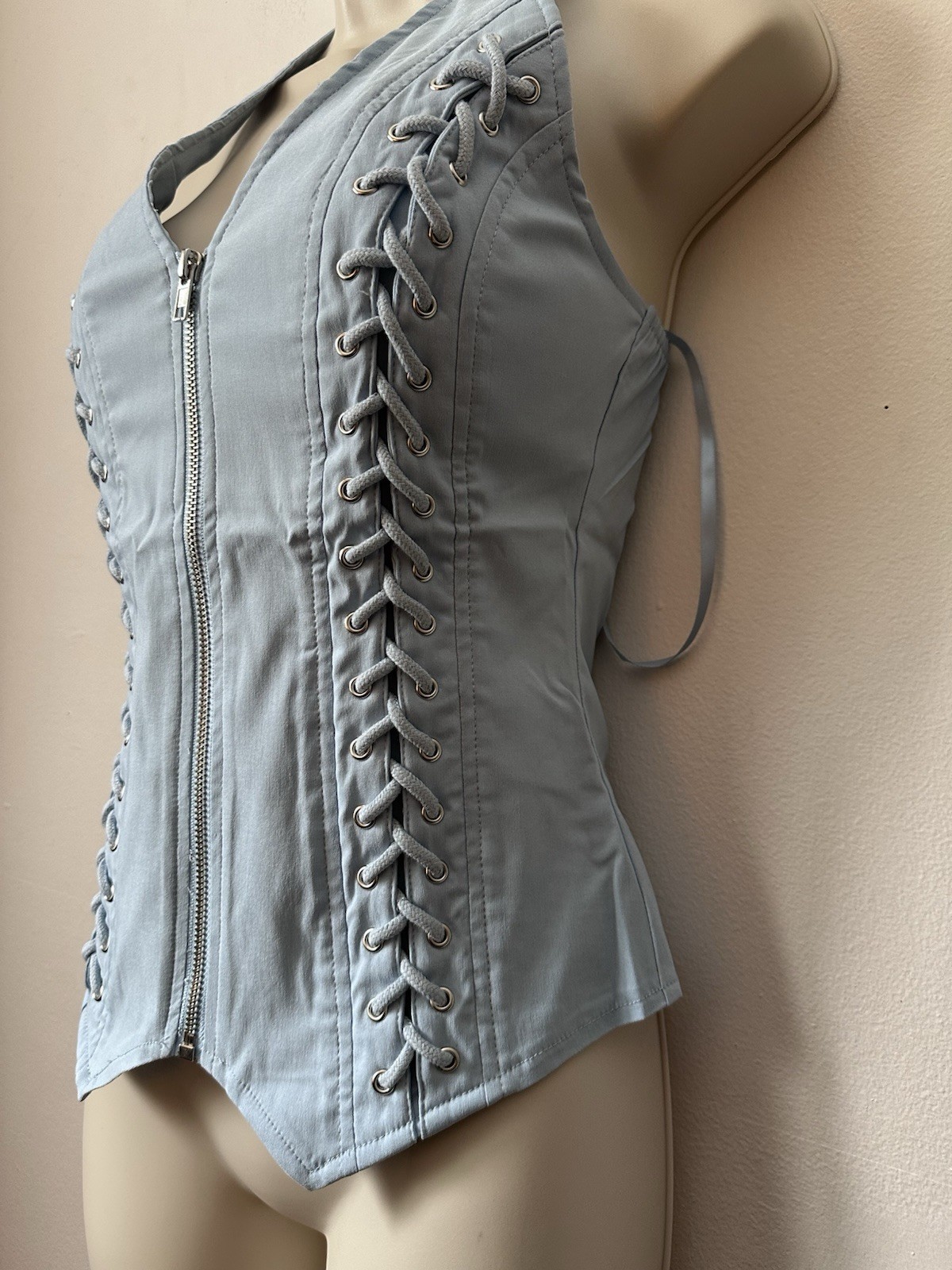 Light blue corset top with zipper and lace up details