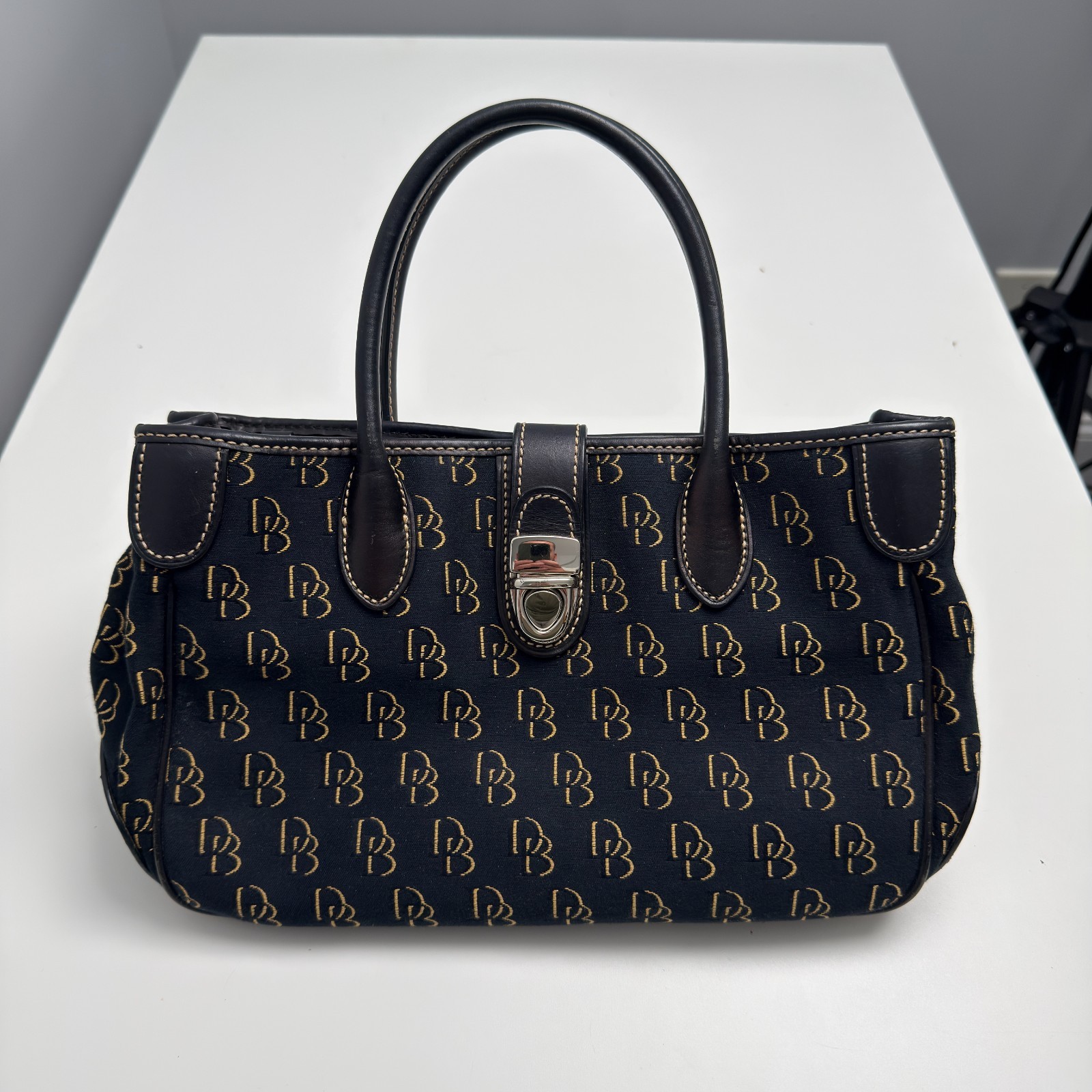 Dooney & Bourke DB Monogram Satchel Purse Black Gold Leather Trim Push Lock