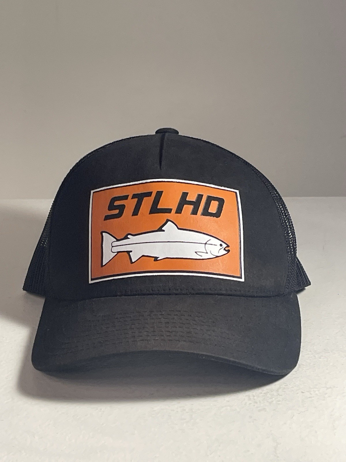 The Classics Men’s Trucker Hat Fish Patch Logo Black Orange Mesh Back Adj L