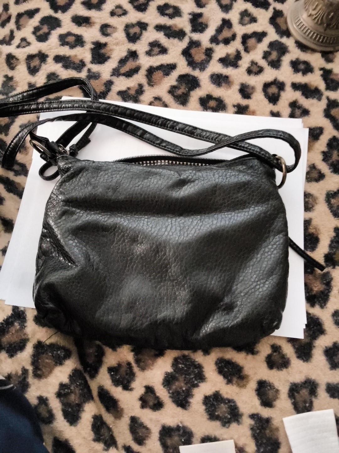Based on the image provided, this black crossbody or shoulder bag features a…