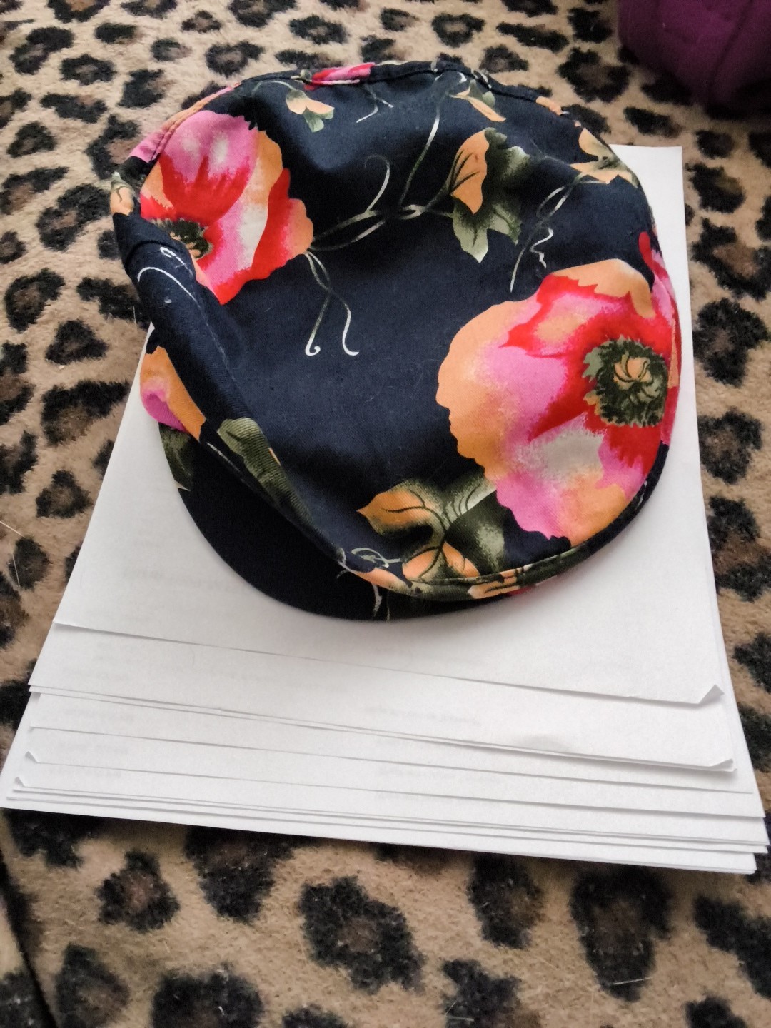 Based on the image provided, this item is a floral print cap, featuring large…