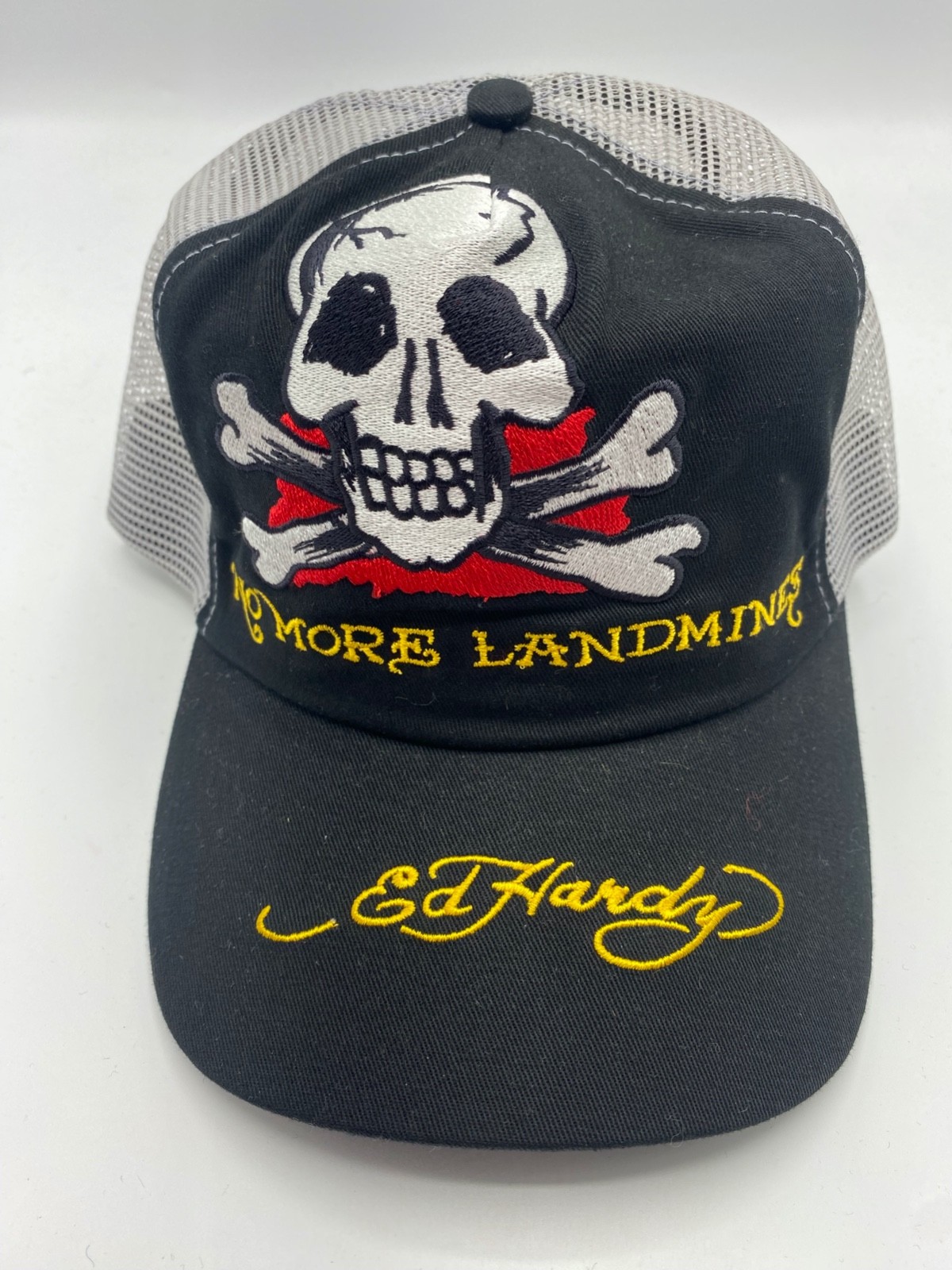 The Ed Hardy “No More Landmines” Skull and Crossbones Black Trucker Hat Cap