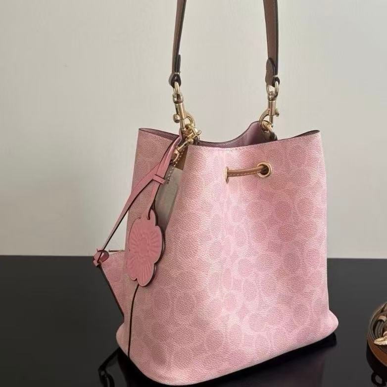 Coach CEA23 Rowan Bucket Bag In Signature Canvas With Charms Powder Pink
