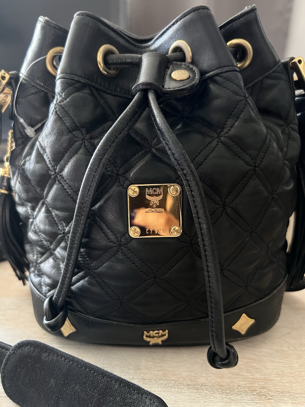 MCM Black Quilted Drawstring Bucket Shoulder Bag Tassel Logo Gold Hardware