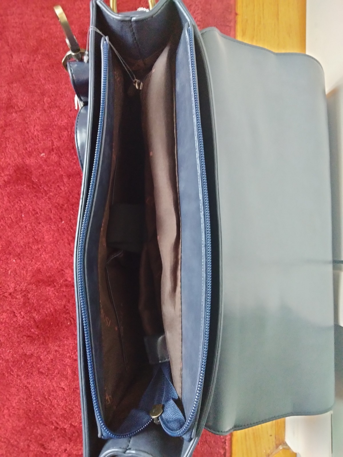 ECOSUSI briefcase features vegan leather construction and a protective handle…
