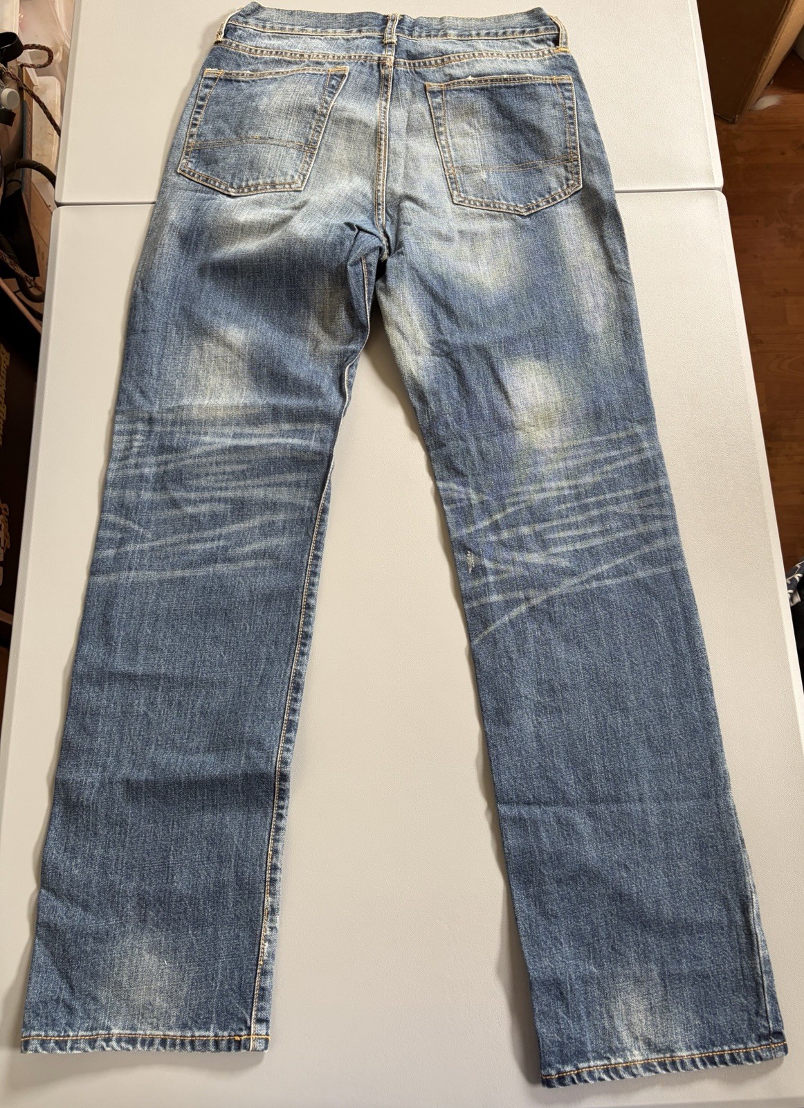 Arizona Jean Co. blue jeans featuring a distressed, light-wash denim style Mens
