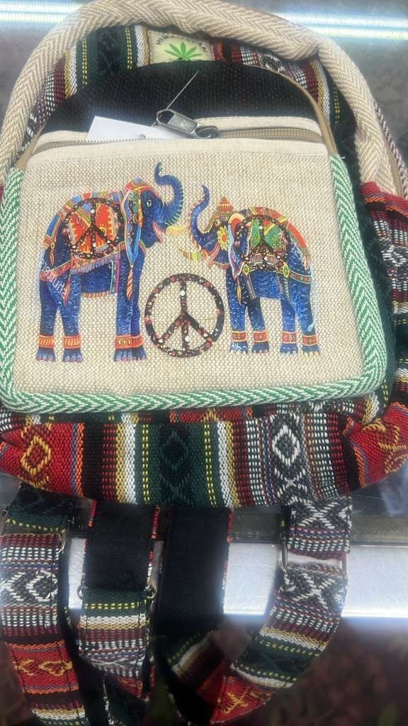 Himalayan Hemp backpack features vibrant, embroidered elephants and a peace sign