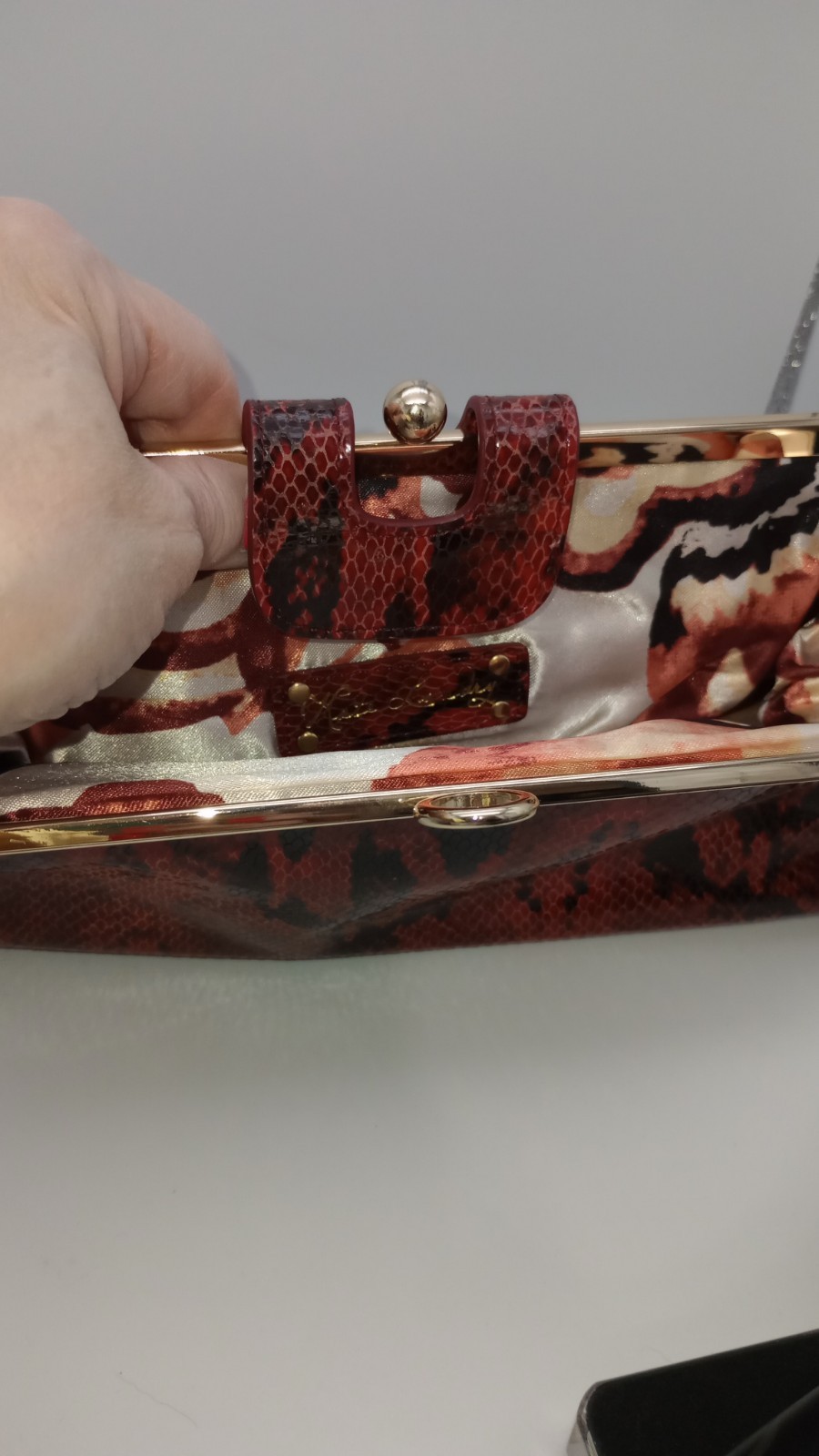 Elevate your style with this stunning Kate Landry Red Leather Clutch Purse.