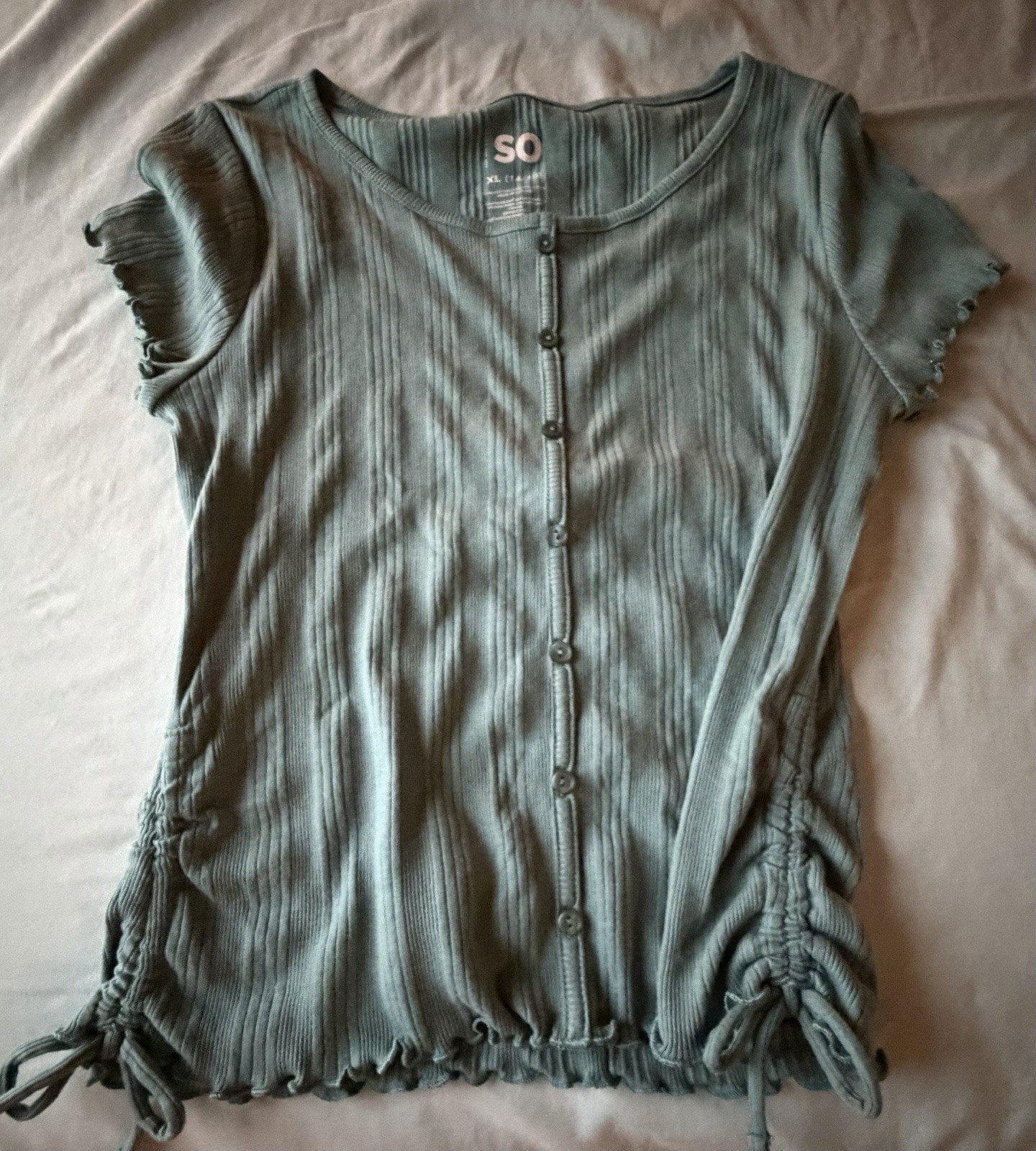 SO cinched button top featuring a distinctive sage green and ribbed texture.