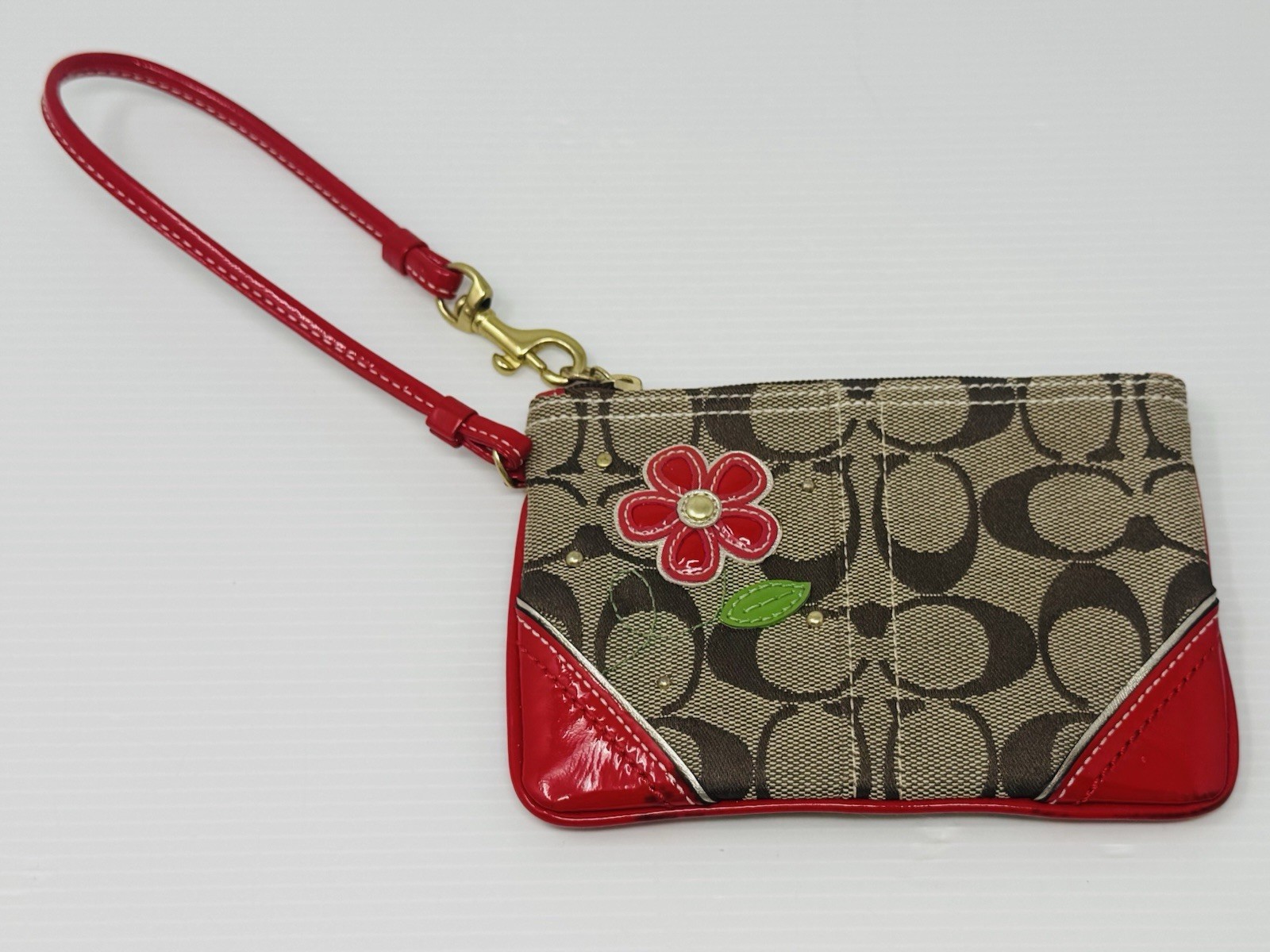 Coach Wristlet with Red Flower and Diamante Detailing in “CC” Monogram