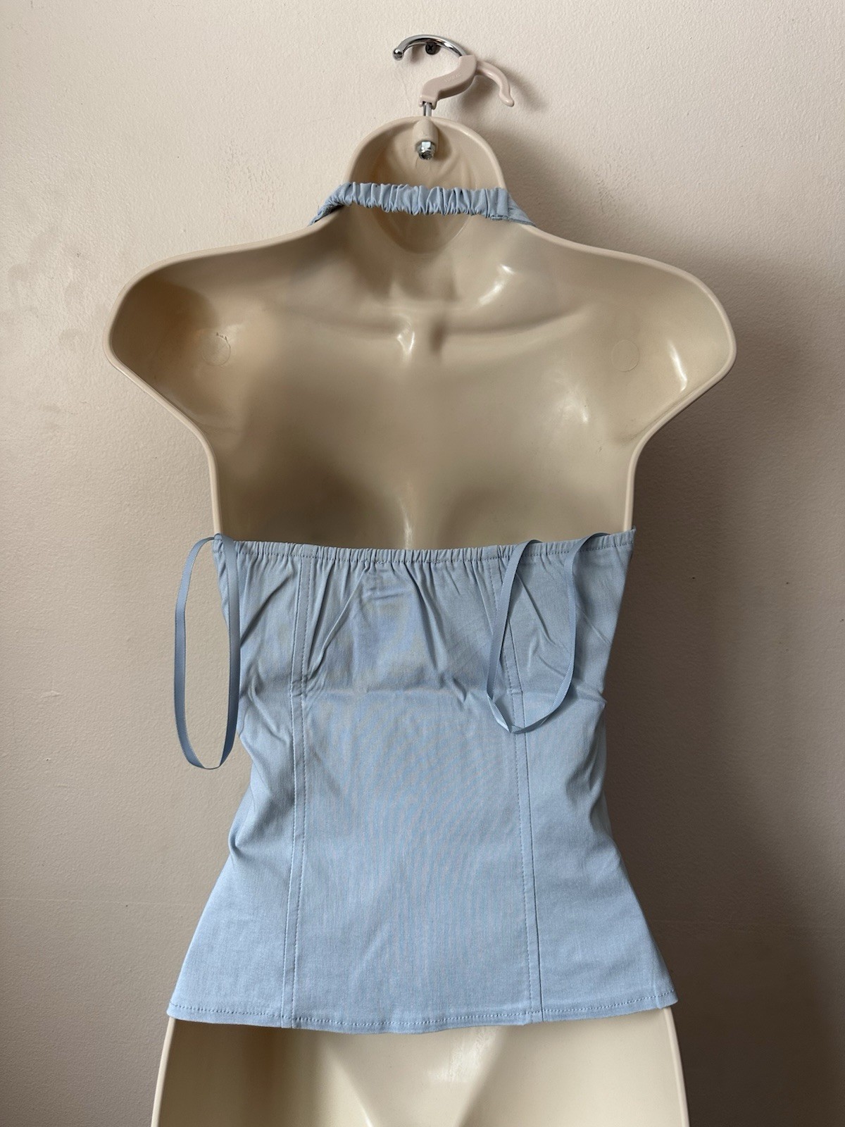 Light blue corset top with zipper and lace up details
