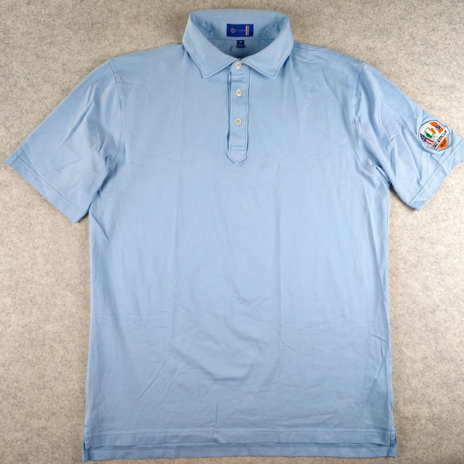 Stitch Polo Medium Blue Solid Cotton Stretch 2022 QM Cup Ireland Logo