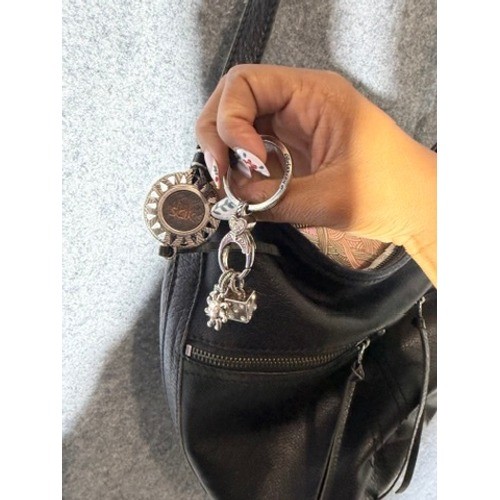 The Sak Black Pebbled Leather Crossbody Hobo Bag Silver Logo Charms Zip Pocket