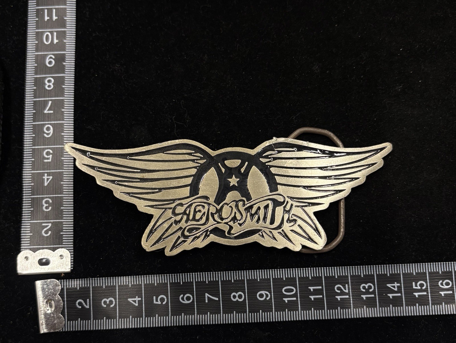 Vintage Aerosmith belt buckle features a metallic wings logo design RARE