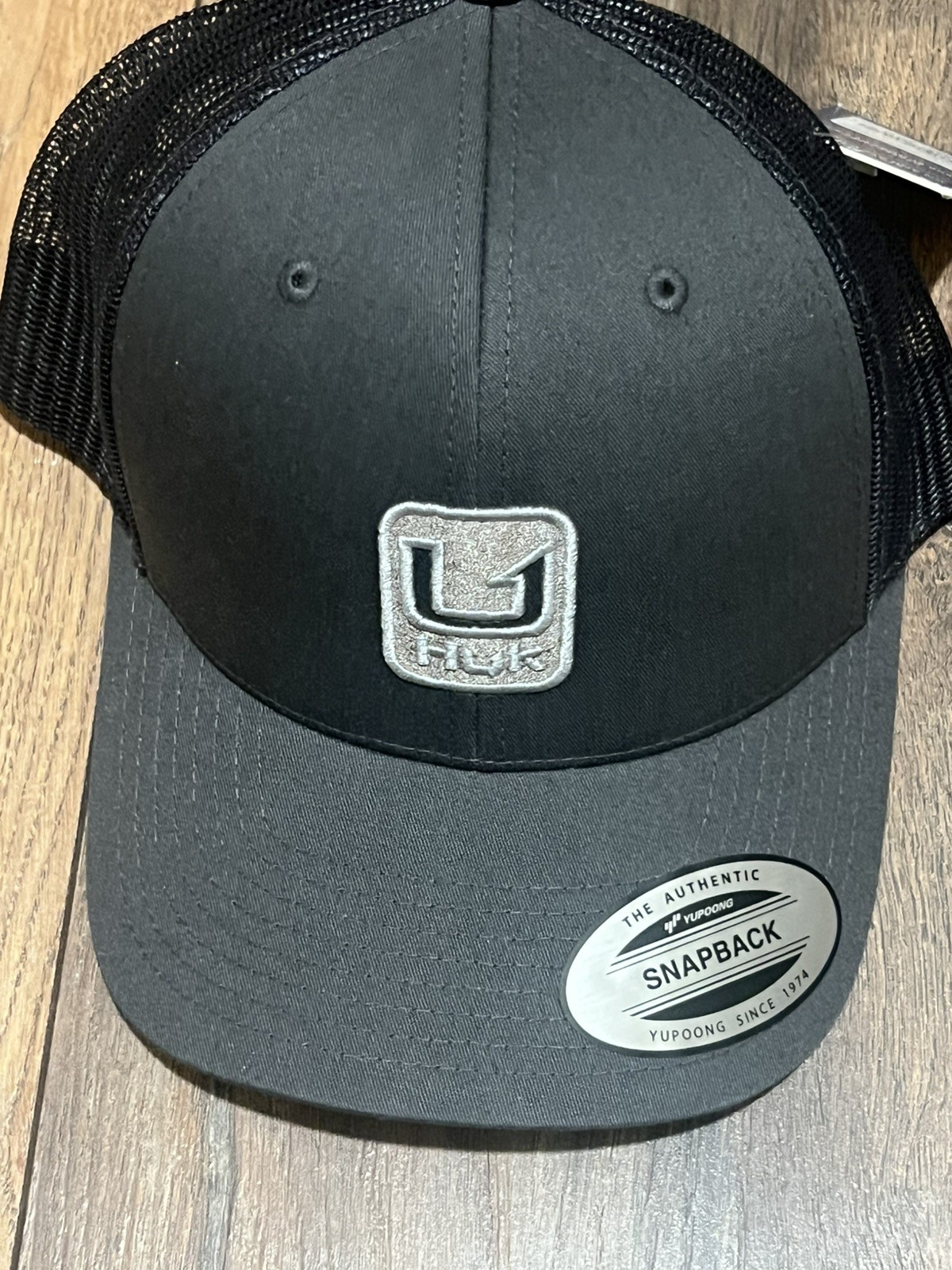 HUK Men’s Stacked U Volcanic Ash Trucker Hat (H3000559-013-1)