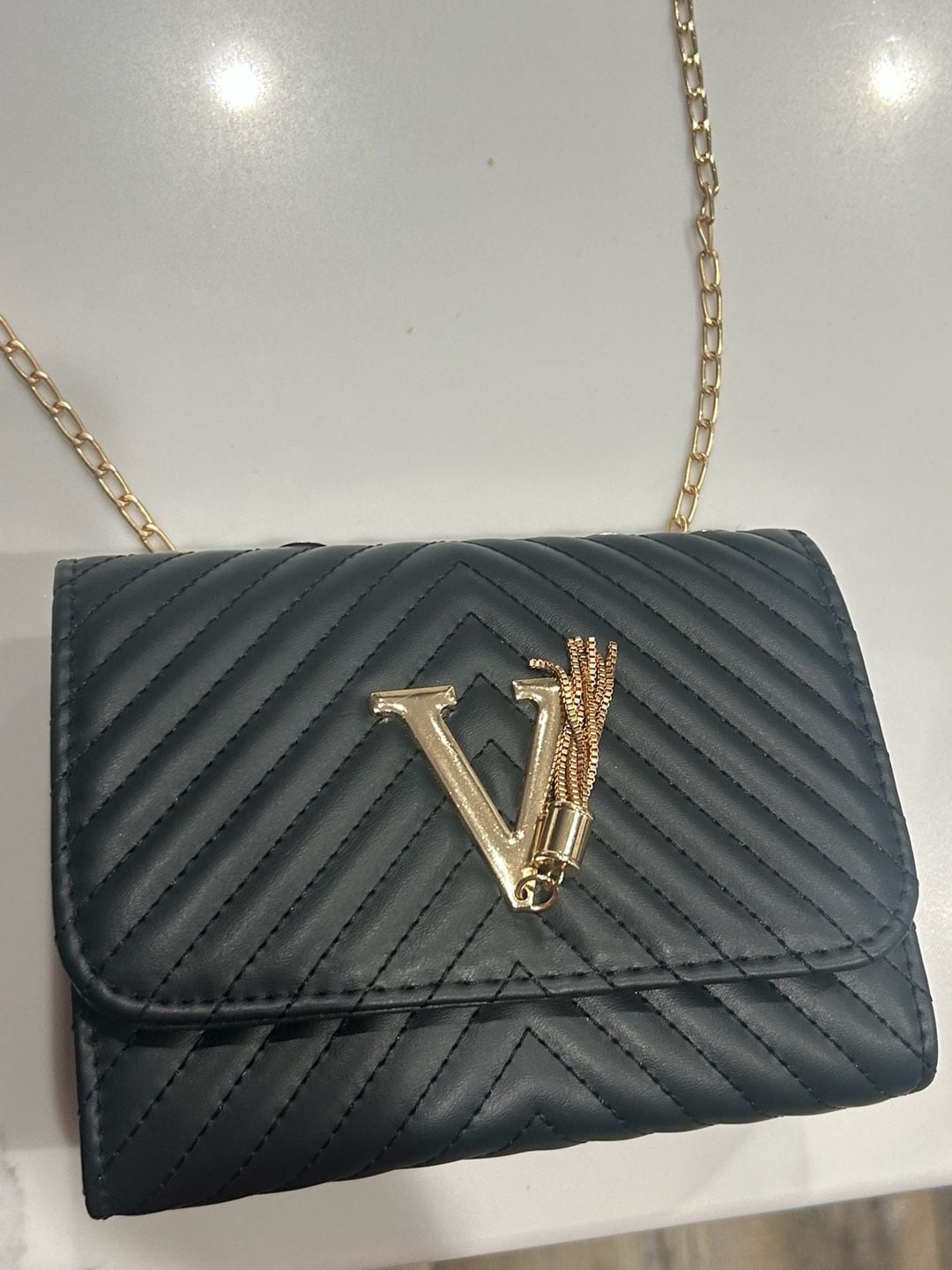 V-Logo Quilted Black Crossbody Bag with Gold Chain and Tassel