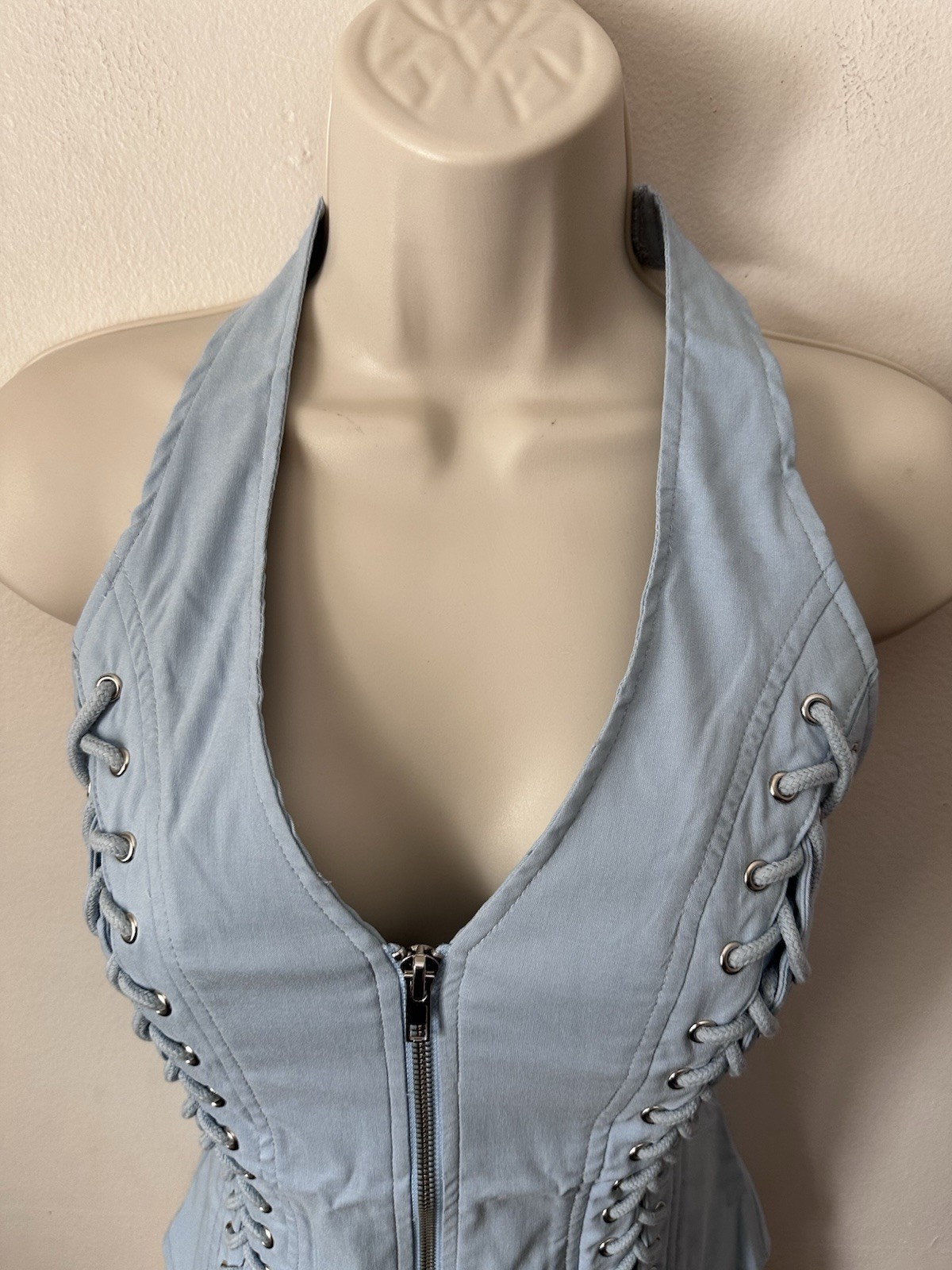 Light blue corset top with zipper and lace up details