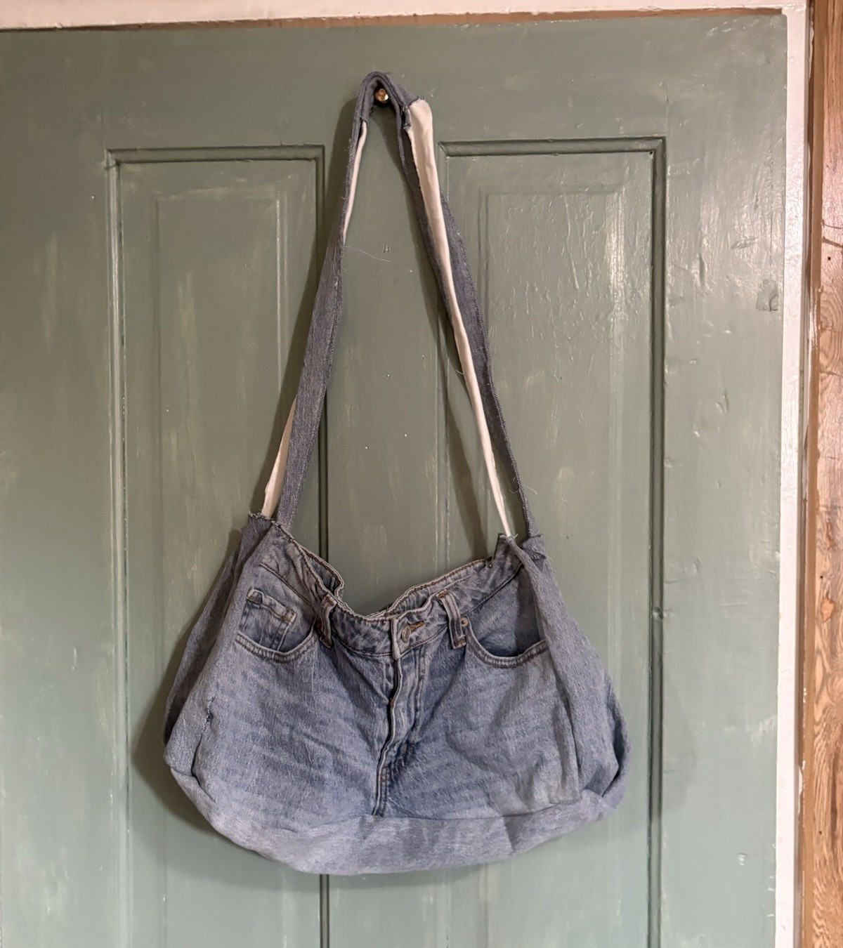 hand made jean/denim tote bag with fully functional pockets, button, and zipper