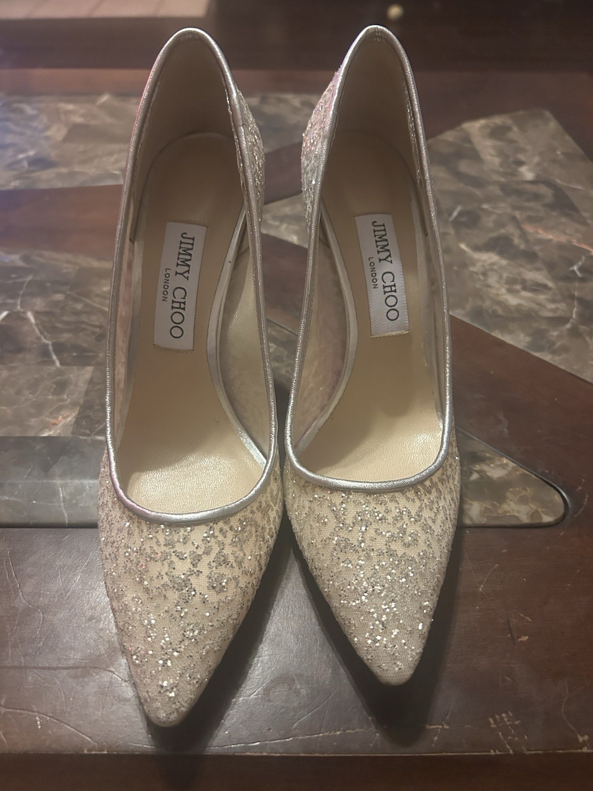 the Jimmy Choo Romy Silver Glitter Tulle and Metallic Nappa Pumps.