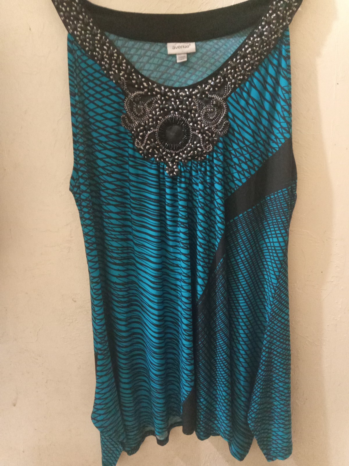 This Avenue tuniic top has a timeless and Claasy appearance With black…