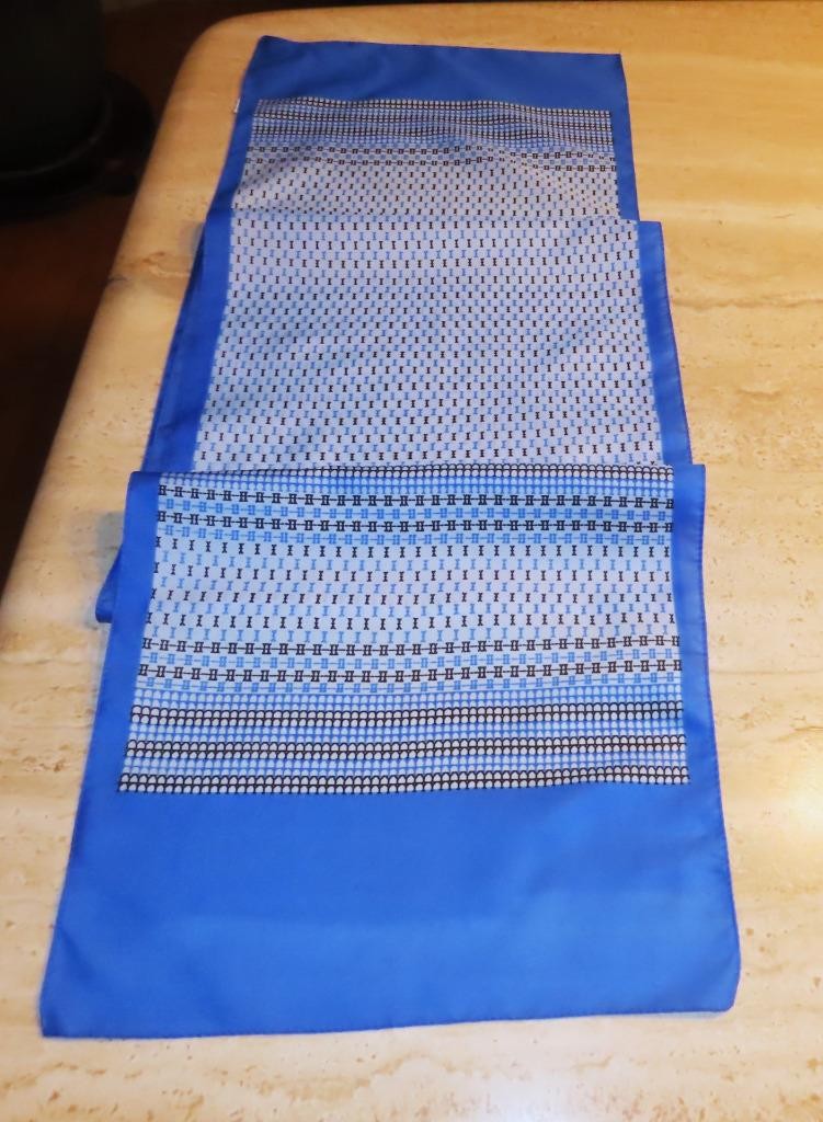 Oblong abstract scarf; blue tones, white; polyester; 54 x 10.5 inches