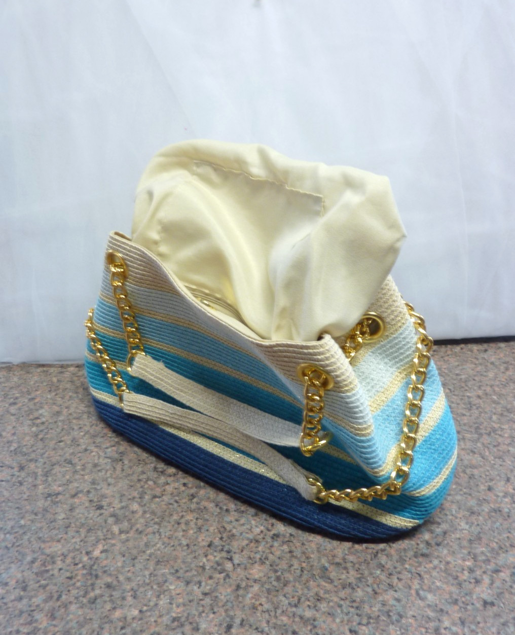 Cool-tone stripe straw chain tote size 15x8x6 inches.