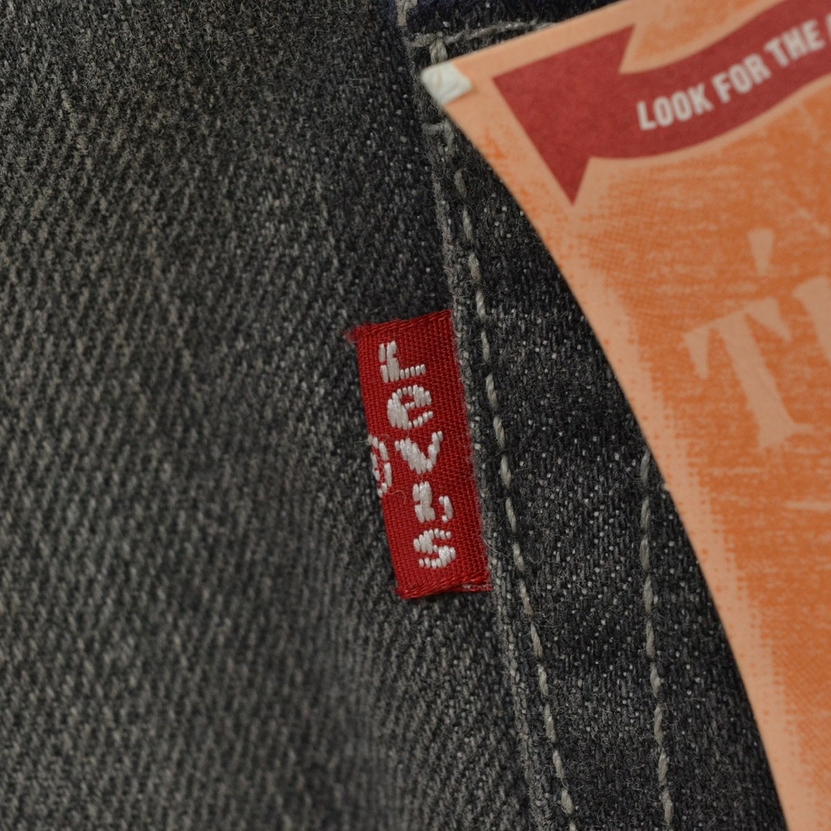 Unused LEVI’S denim jeans, model number 00501-1615, size W30, gray.