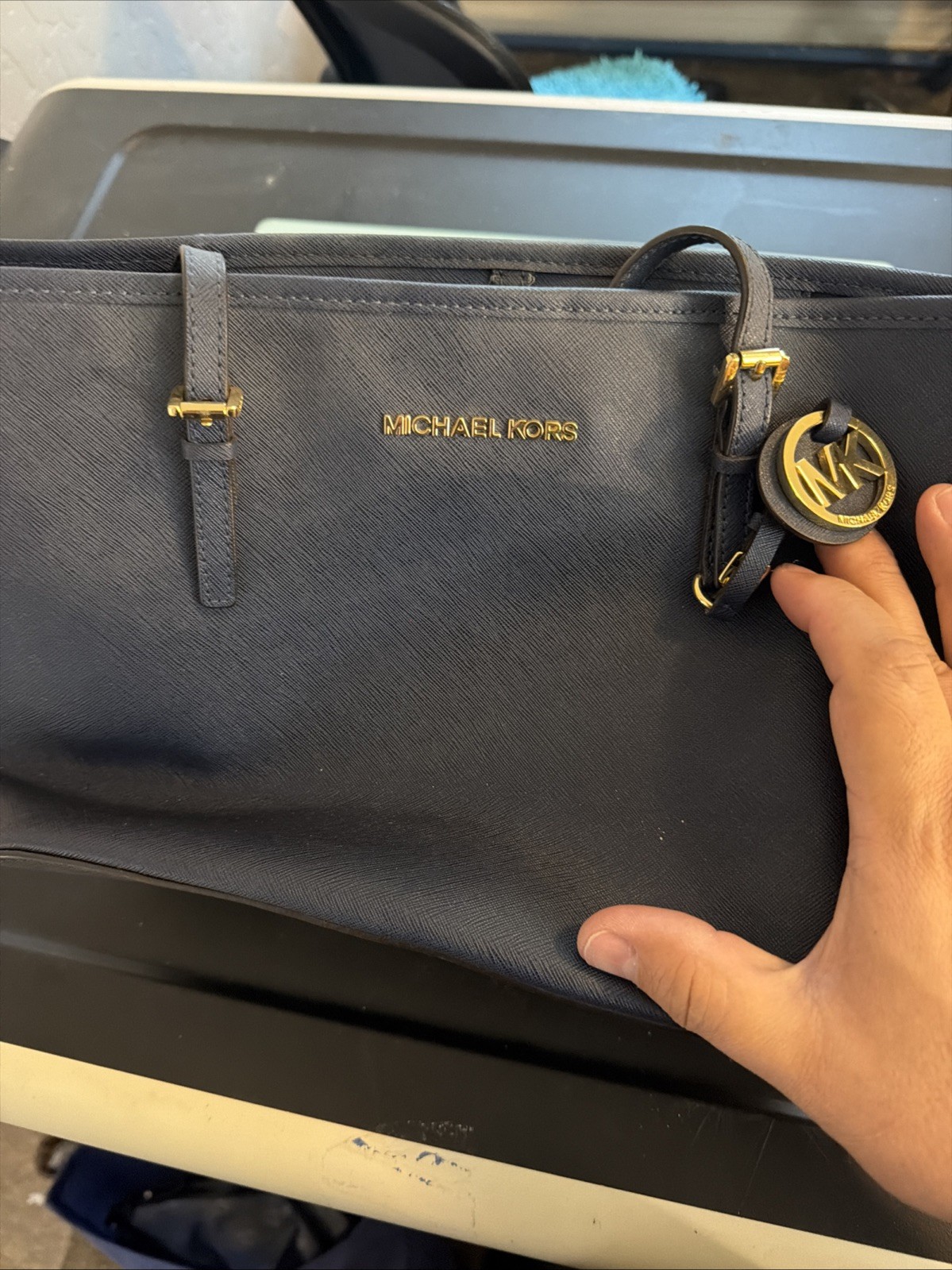 Michael Kors tote features gold-toned hardware distinctive front buckle strap