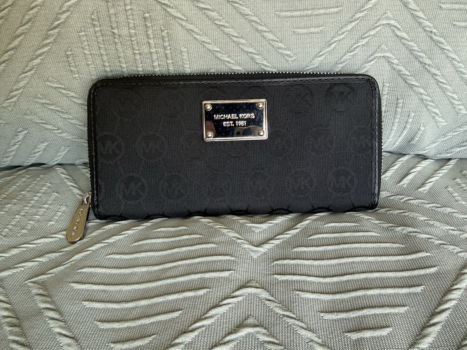 Michael Kors black zip around wallet with gold “Michael Kors Est 1981” Logo