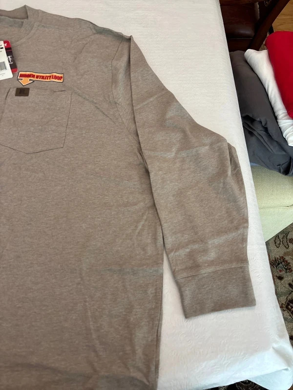 Grey long sleeve Wrangler work shirt. Front pocket with utility hook. Brand new