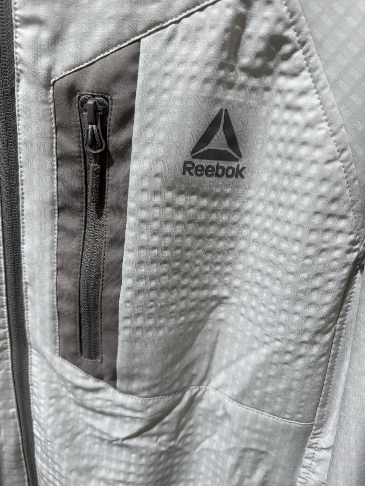Reebok Men’s Textured Stretch Hooded Jacket, Windbreaker Driftwood Black M-3XL