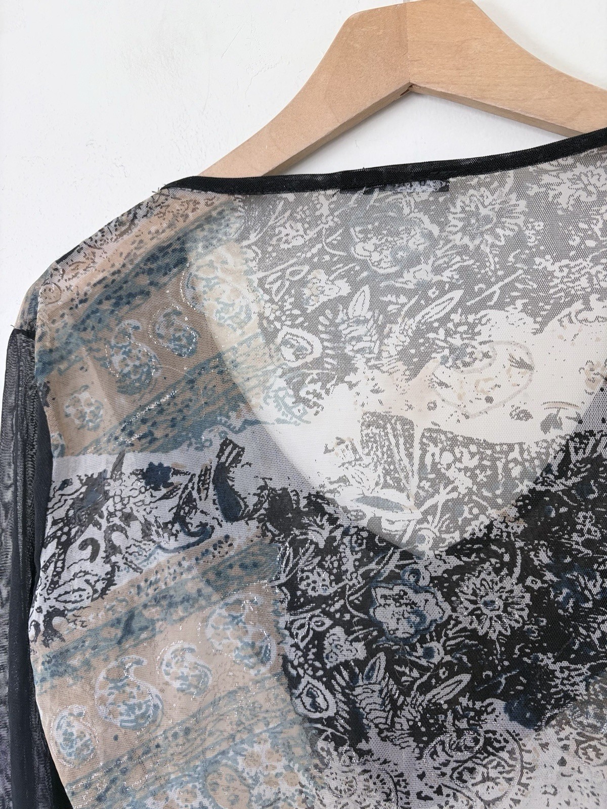 Vintage long sleeve top features a grey and black paisley print with intricate b
