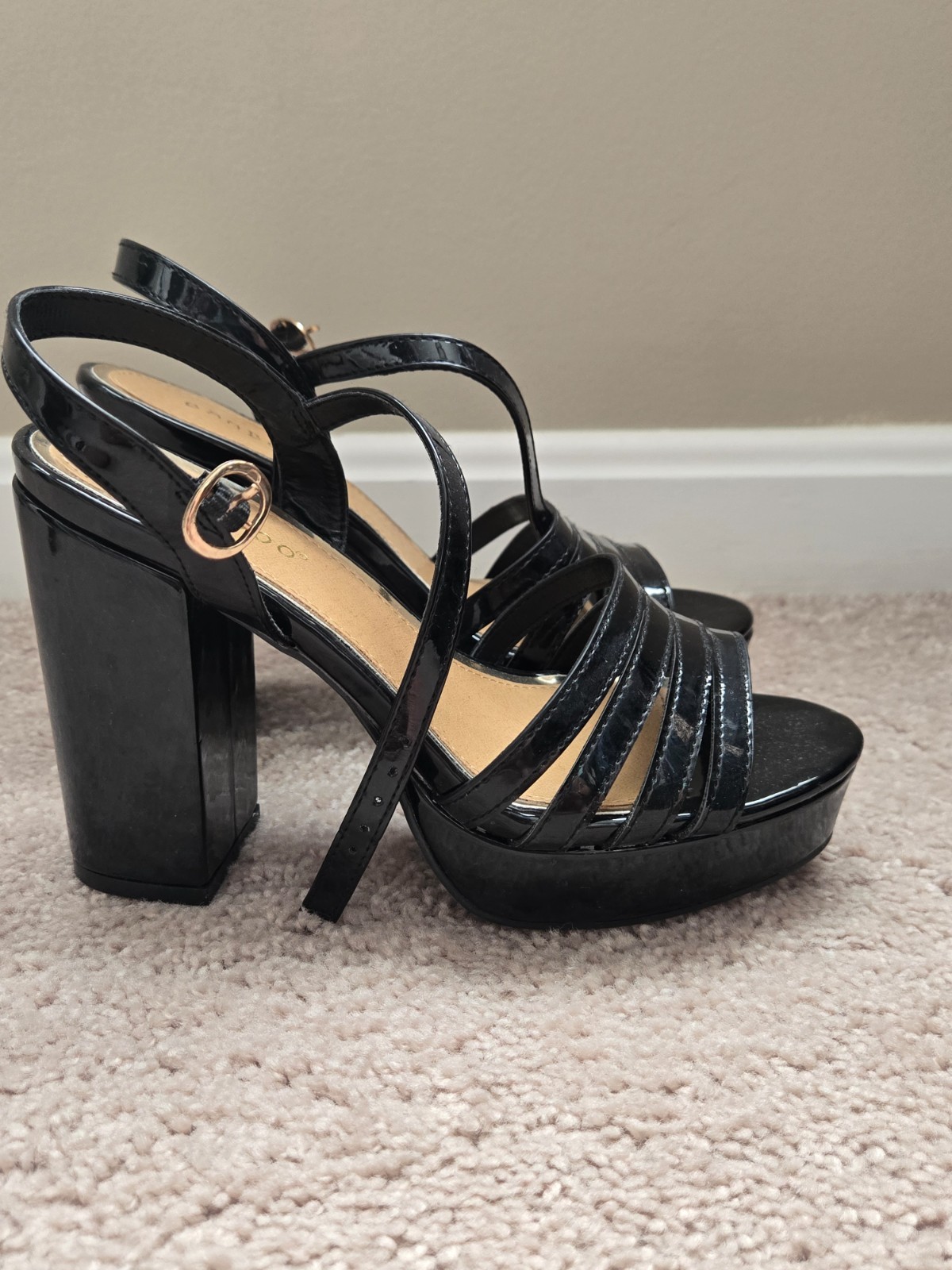 Brand new. Size 6.5. Never worn. Black faux leather. Strap