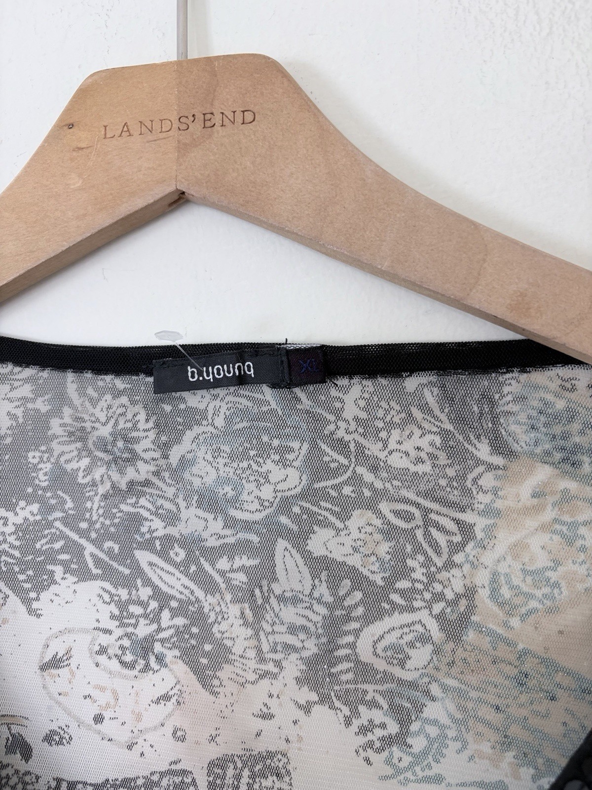 Vintage long sleeve top features a grey and black paisley print with intricate b