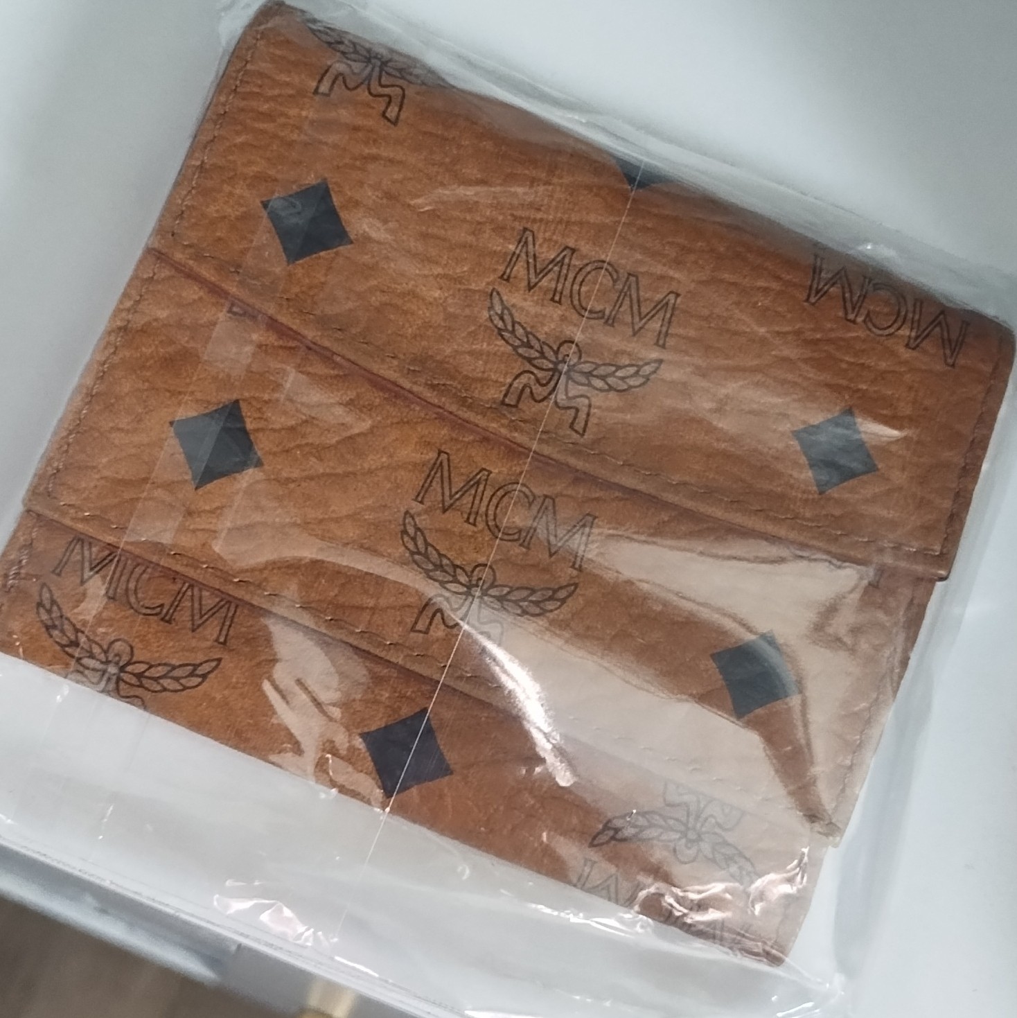 MCM Brown Logo Print Folding Wallet for Unisex with MCM Character Logo Theme