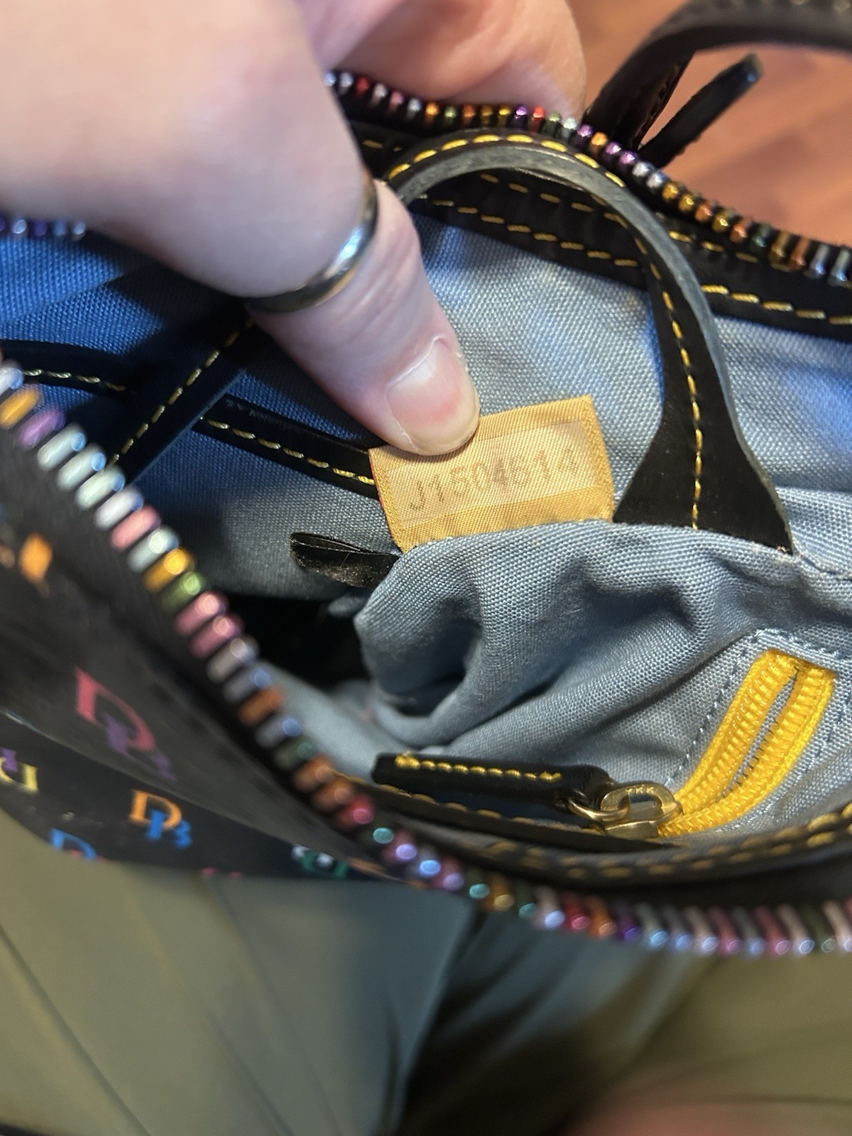 This Dooney & Bourke DB75 Multi rainbow logo crossbody bag