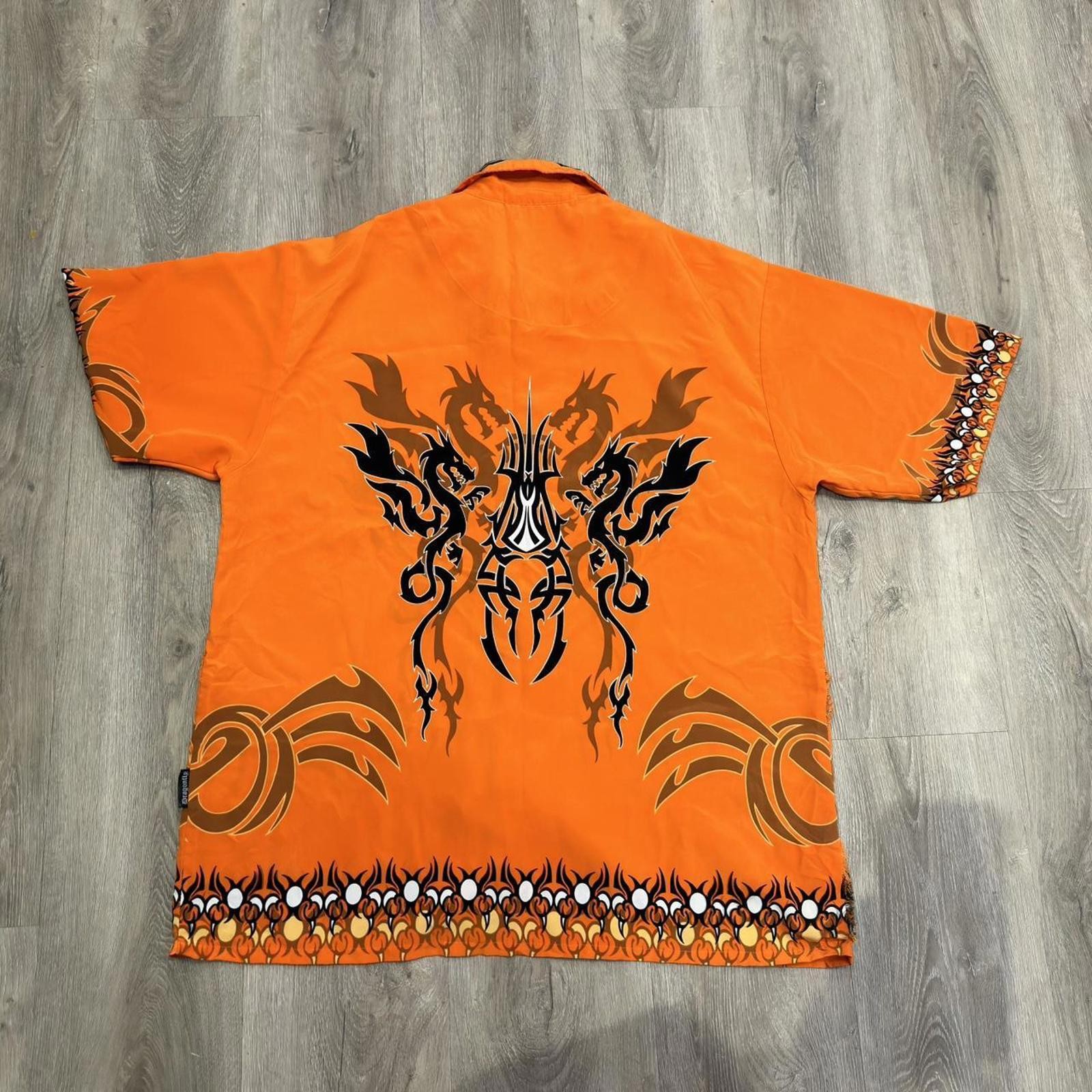 Orange and black dragon button up shirt with a small hole can be sewed size xl