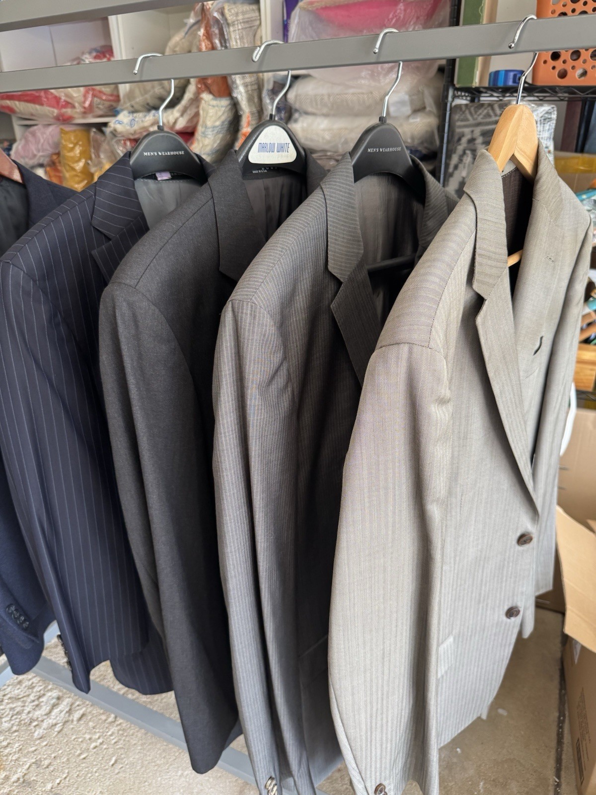Set of four HUGO BOSS suits/blazers in various sizes/shades of blue and gray.