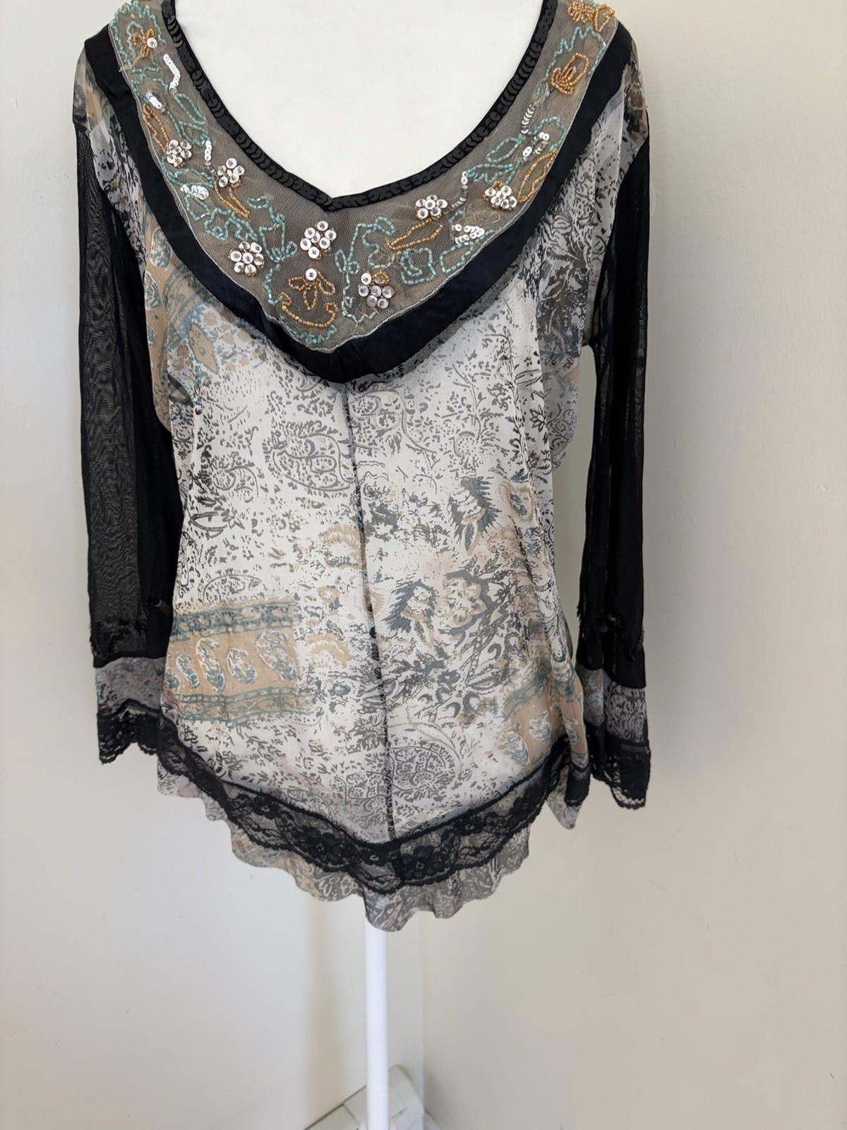 Vintage long sleeve top features a grey and black paisley print with intricate b