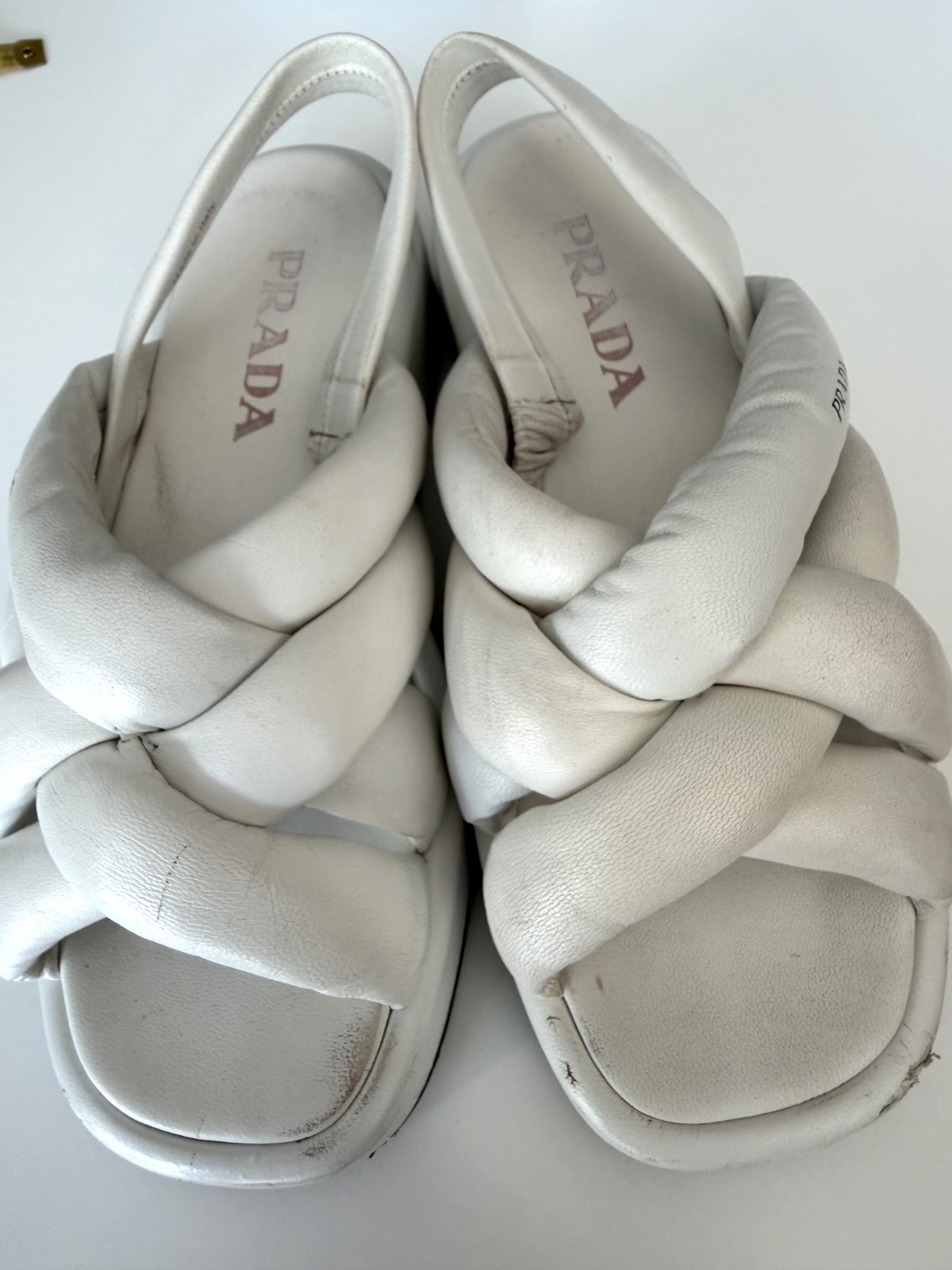 Women’s PRADA Padded Nappa Leather Flatform Sandals in white. Size: 38.5 EU