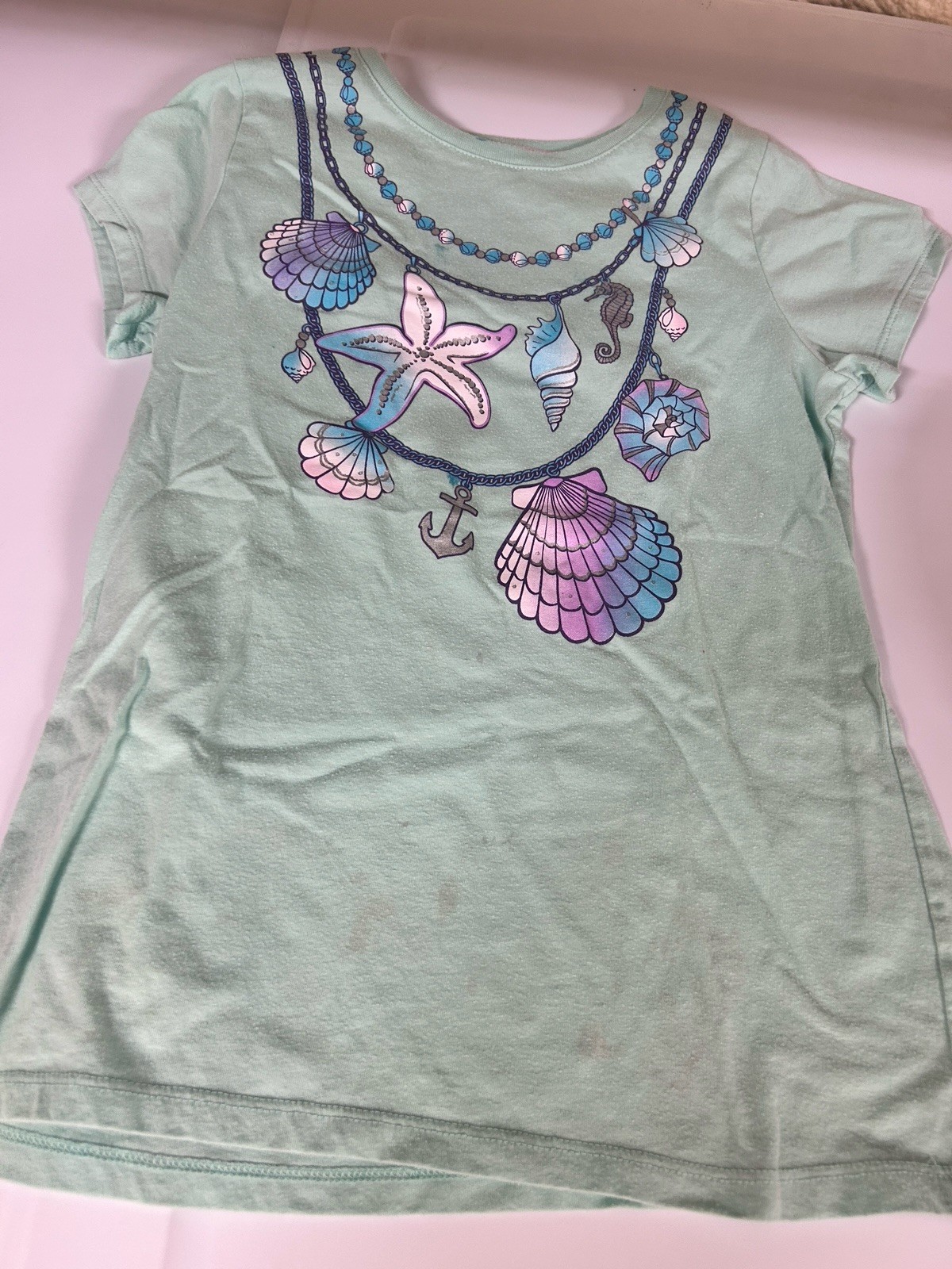 mint green tee with a seaside shell and starfish necklace graphic. Girls L 10-12