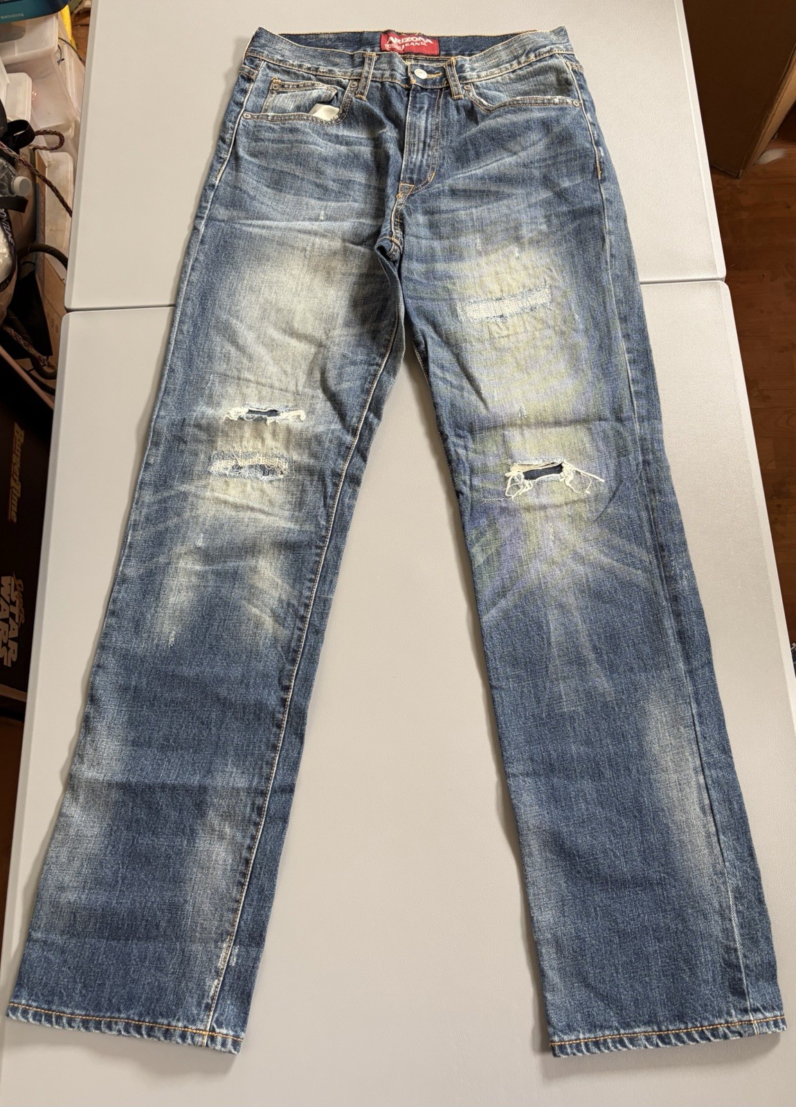 Arizona Jean Co. blue jeans featuring a distressed, light-wash denim style Mens
