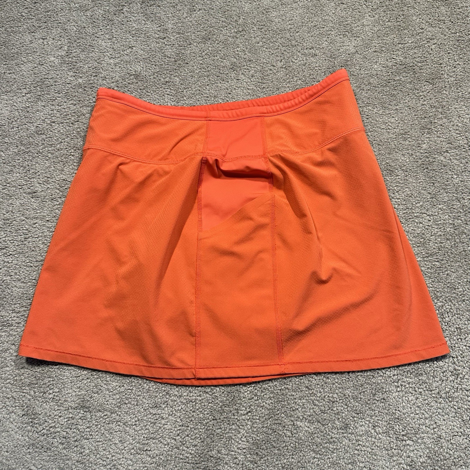 ATHLETA Action Skort in Dobby 14.5 Womens Small Orange Pockets Stretch Athletic