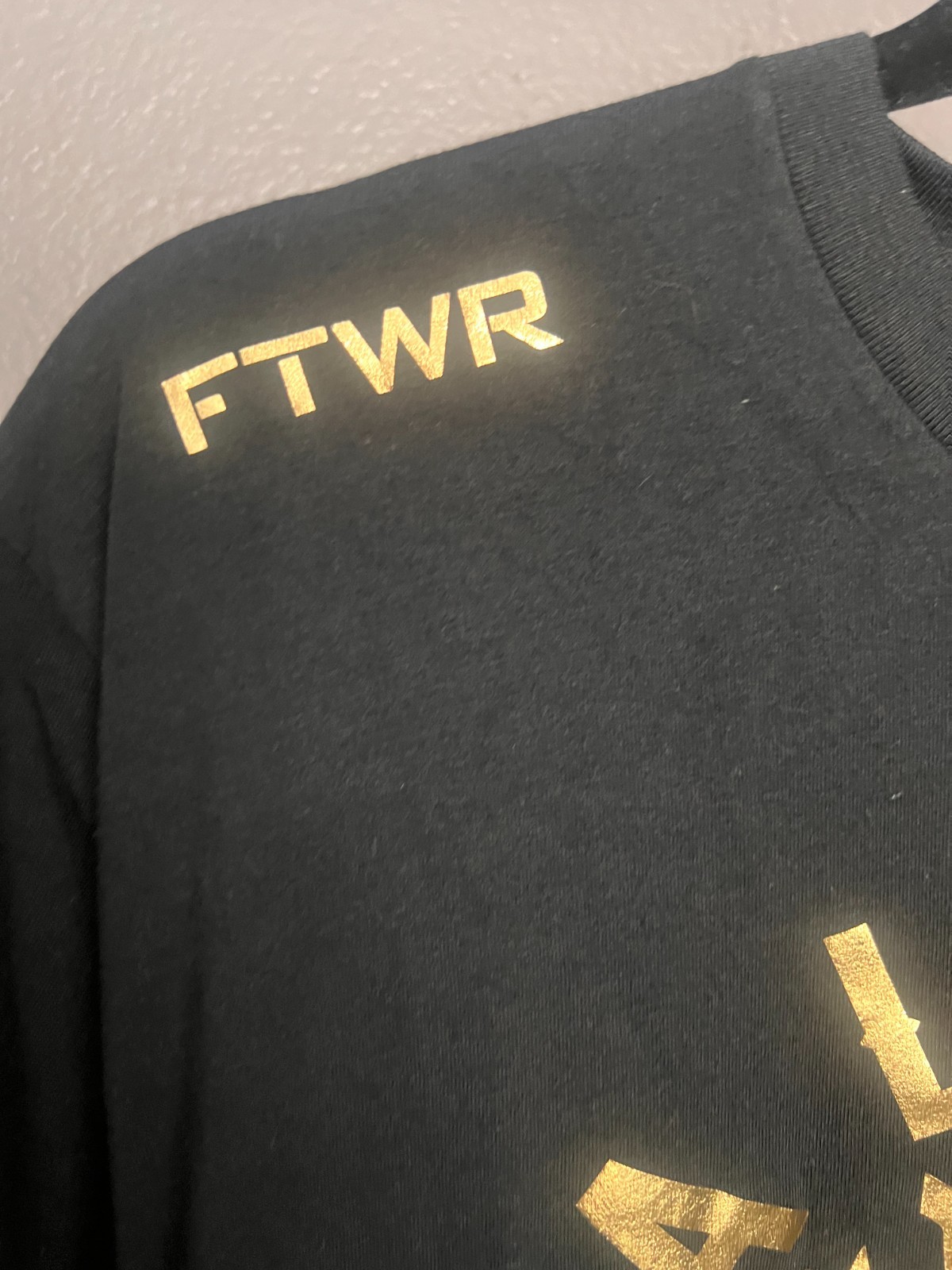Black Alexa Grasso t-shirt with gold screen-printed graphics. Large